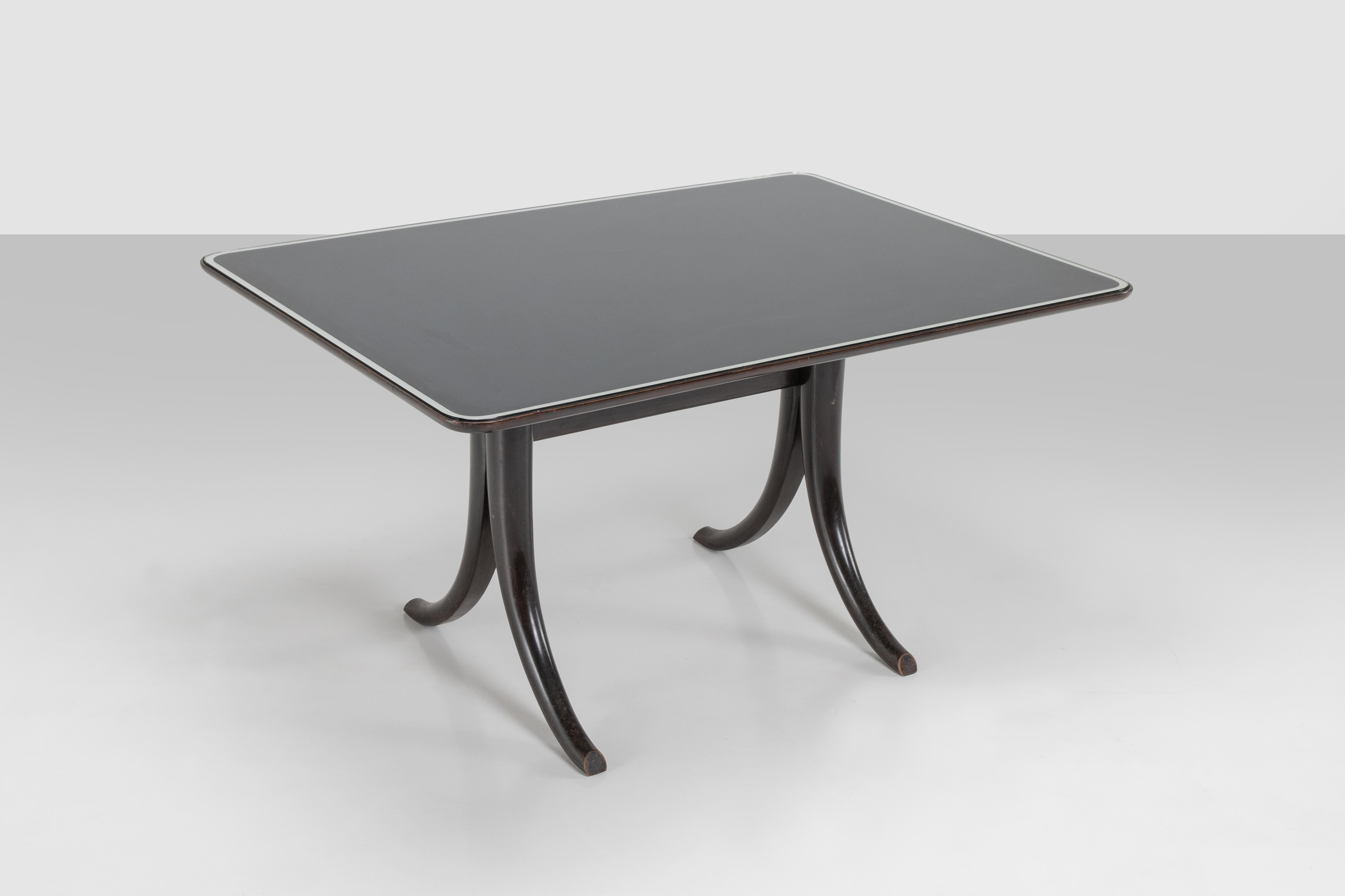 Rare table in ebanized wood with glass top, this piece comes from a private apartment near Venezia where it was with other furnitures of the same elegance. The typical feet brought us to understand the idiosyncratic touch of Pietro Chiesa, one of