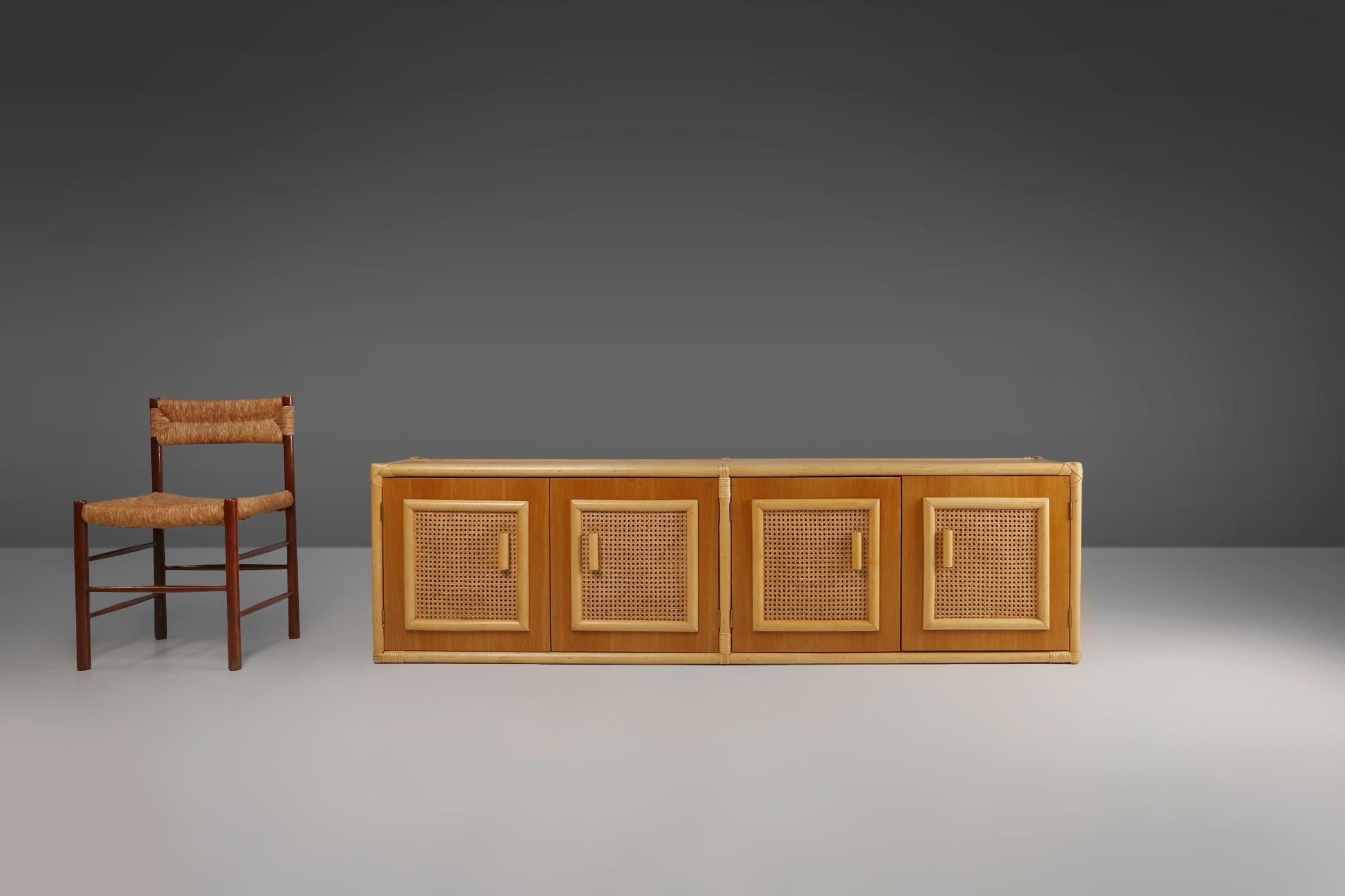 France / 1960s / sideboard / rattan and wood / mid-century / vintage / design

A rare to find French bohemian style sideboard with 4 rattan doors and  neatly finished back, designed in the sixties. With a beautifully crafted frame and decorative