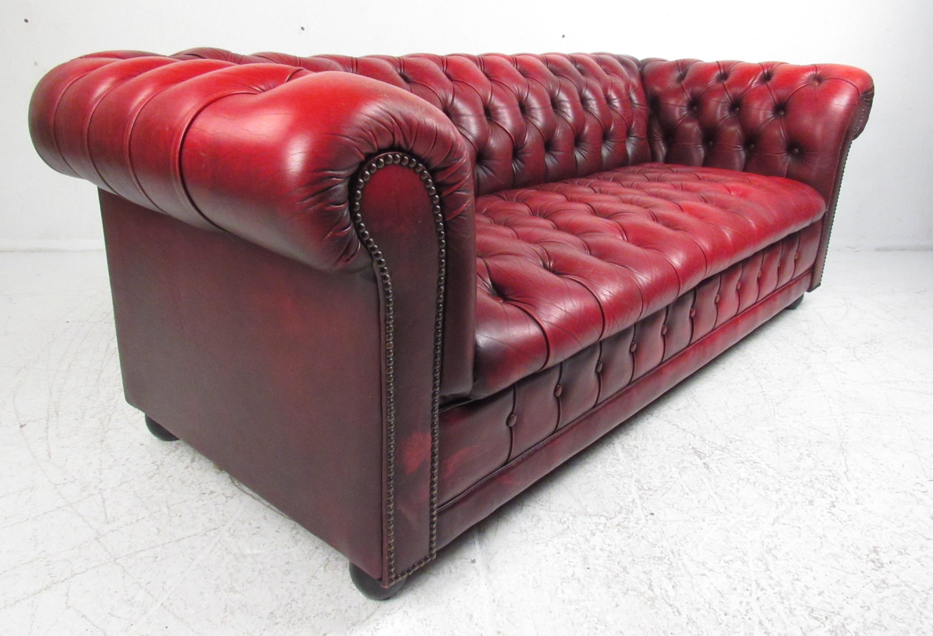 All original tufted Chesterfield with Classic rolled arms, bun feet, and distressed cracked leather. Please confirm item location (NY or NJ) with dealer.

  
