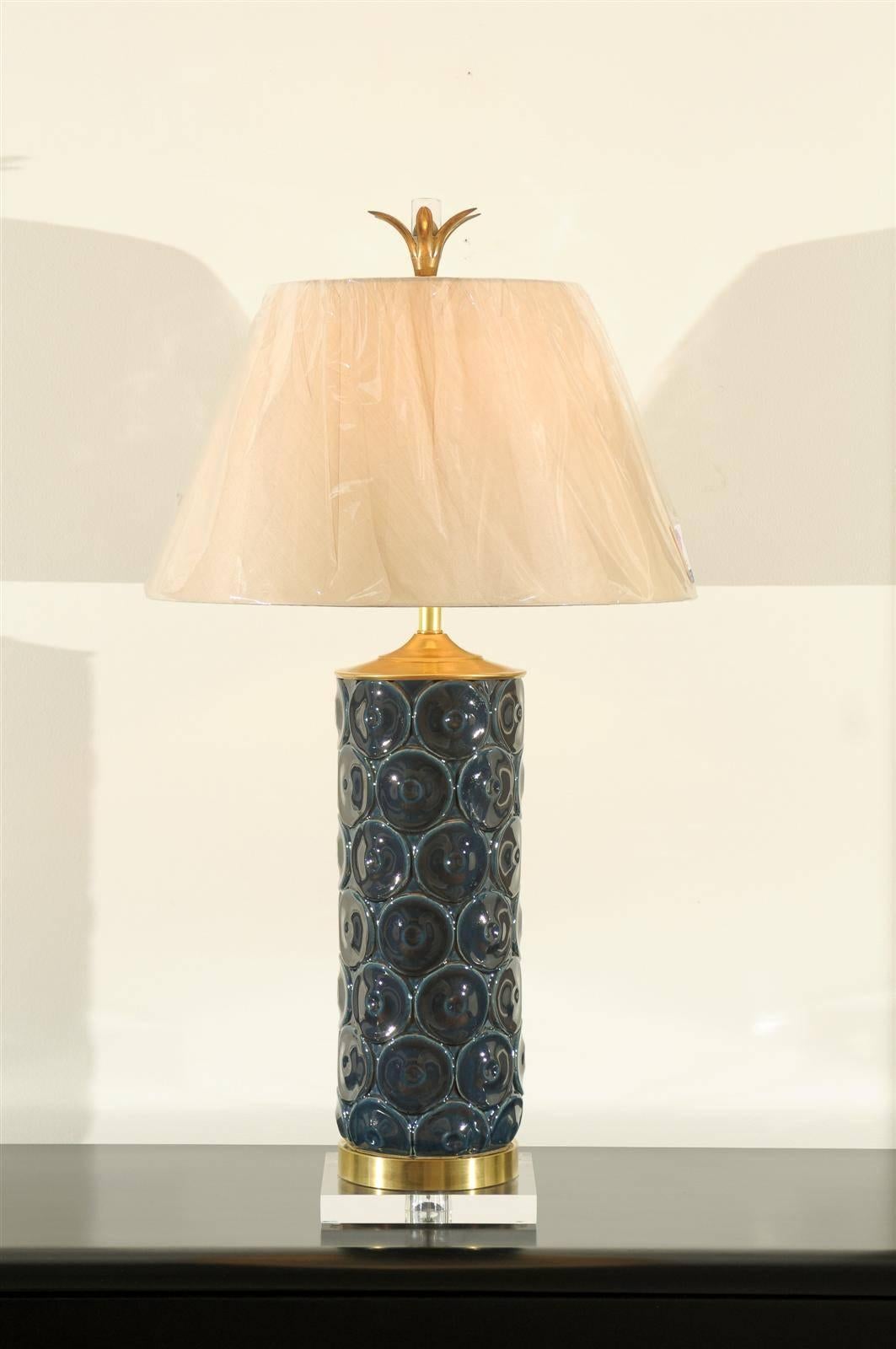 These magnificent lamps are shipped as photographed and described, complete with new shades, harps and finials. 

A stellar pair of large-scale lamps, circa 1970. Textured glazed ceramic vessels with solid brass accents atop a Lucite base. Beautiful