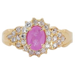 Elegant Ring features a dazzling 1 carat oval natural Ruby center stone
