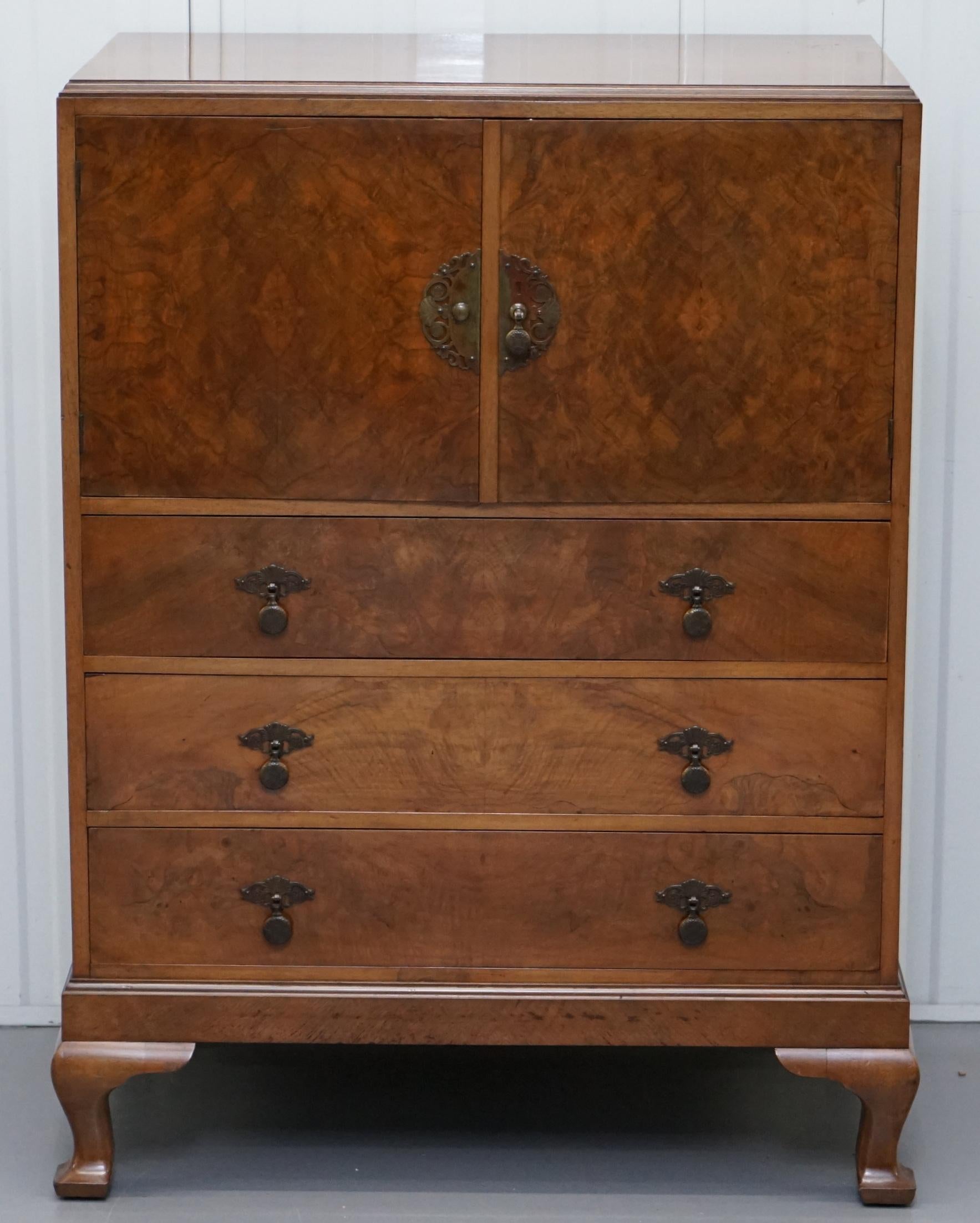 We are delighted to this lovely circa 1910 Burr Wanlut drinks cabinet with drawers made by the great firm of Robson & Sons

A good looking, functional and well made piece of furniture, the drawers all open and close as they should, the top of the