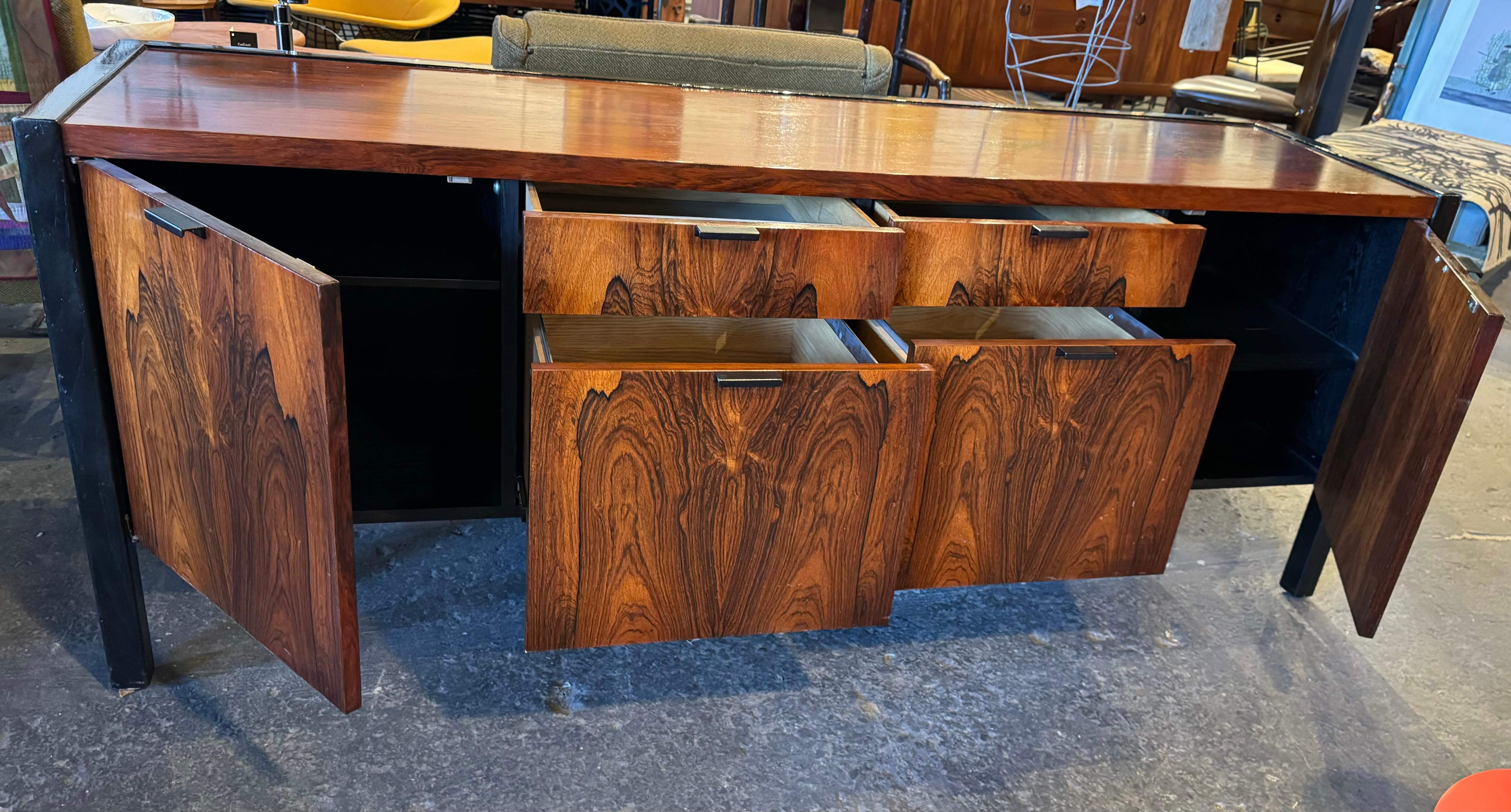 Stunning Rosewood Cabinet / credenza designed by George Nelson / Herman Miller.. Ebonized wood frame and back with an amazing figured rosewood case,Four drawers , including two file drawers and two doors concealing shelved storage. Extremely to find