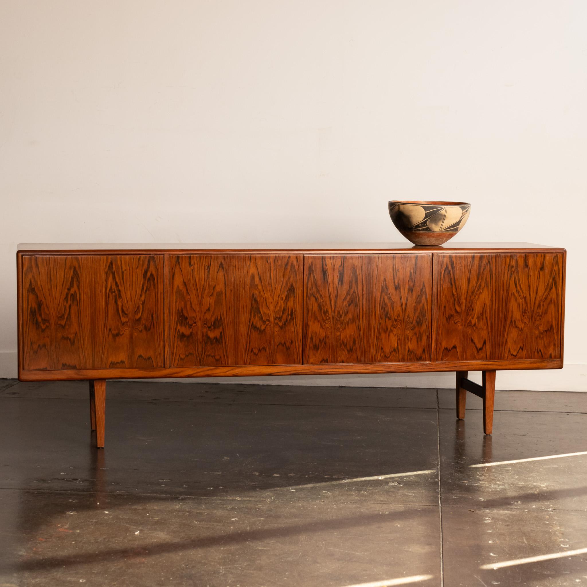 A beautifully executed rosewood credenza by Robert Heritage, an industrial and interior designer in England in the 50s and 60s.  This is a classic example of his work, which featured simple, classic lines and employed beautifully grained woods.