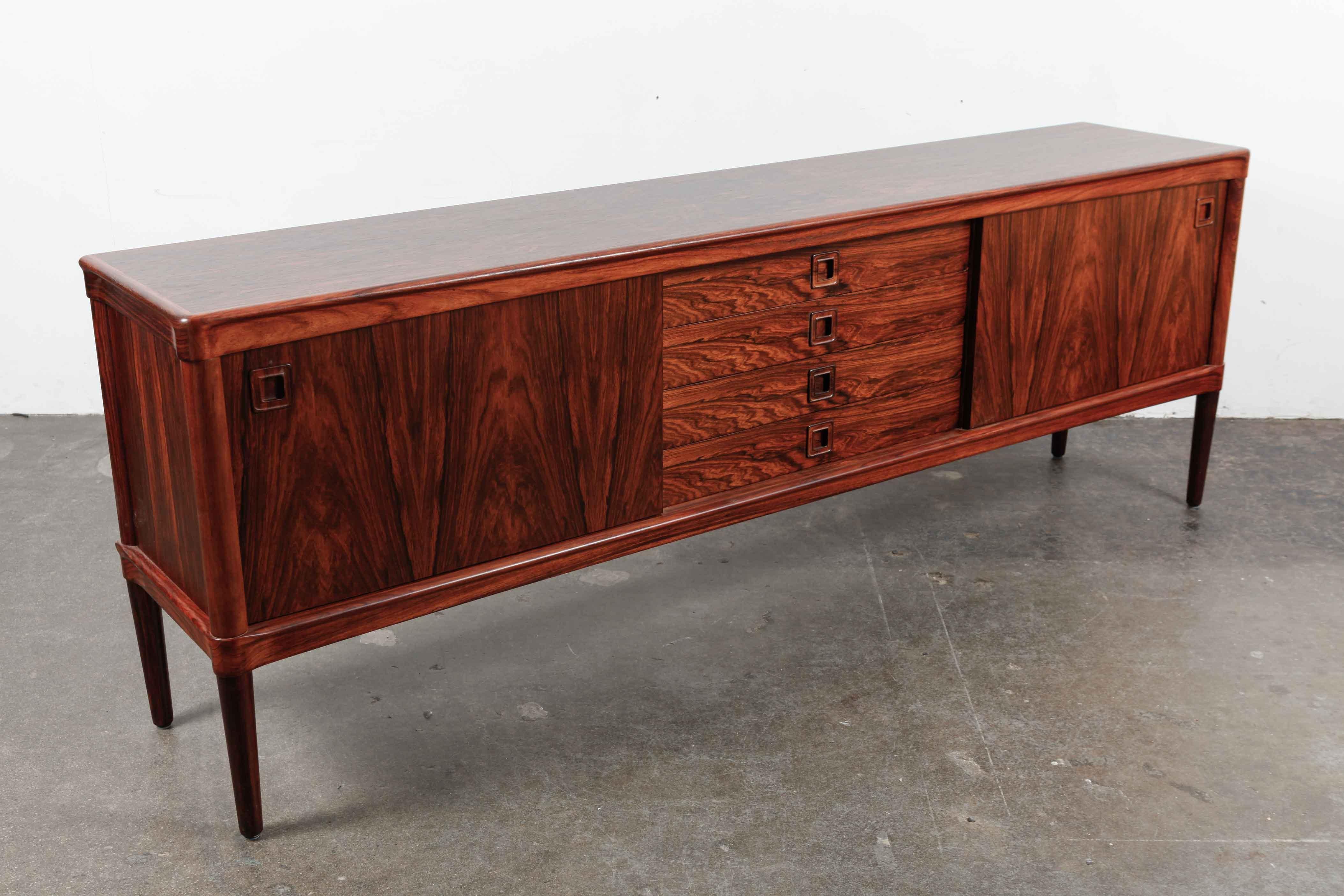 Stunning rare, low and long sideboard by H.W. Klein for Bramin Mobler, Denmark. It has incredible grain throughout and beautiful craftsmanship and details. This sideboard has been newly refinished in a satin lacquer. 

 