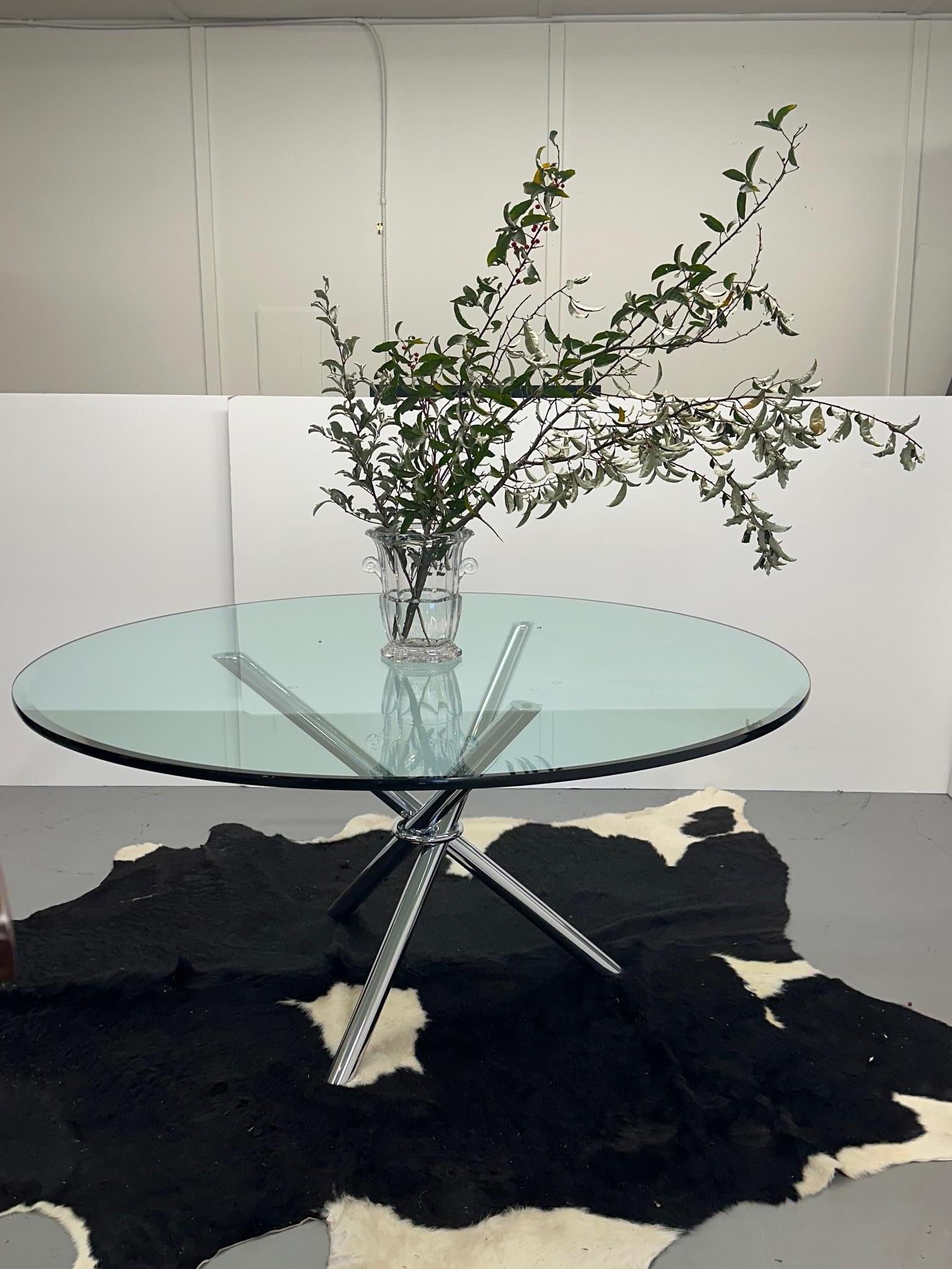 Striking mid century modern round dining or conference table having cool chrome tripod base that folds and 3/4” thick newer glass top.  Glass is beveled on one side.