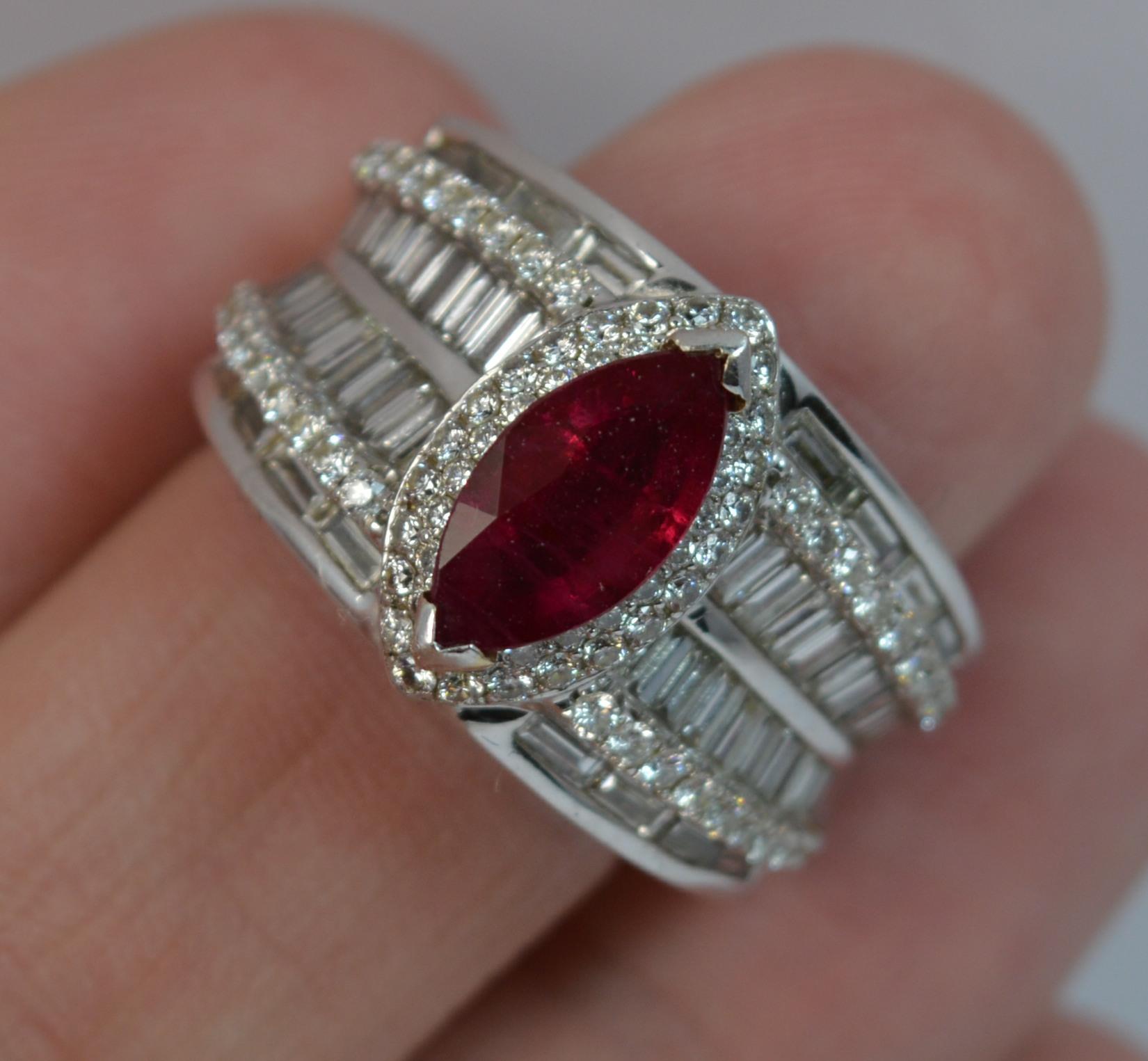 A beautiful Ruby and Diamond ring.
SIZE ; M UK, 6 US
Solid 18 carat white gold example throughout.

Designed with a marquise cut ruby to the centre, 5.3mm x 10.6mm. To each side are 44 natural diamonds of round brilliat and baguette cut diamonds and