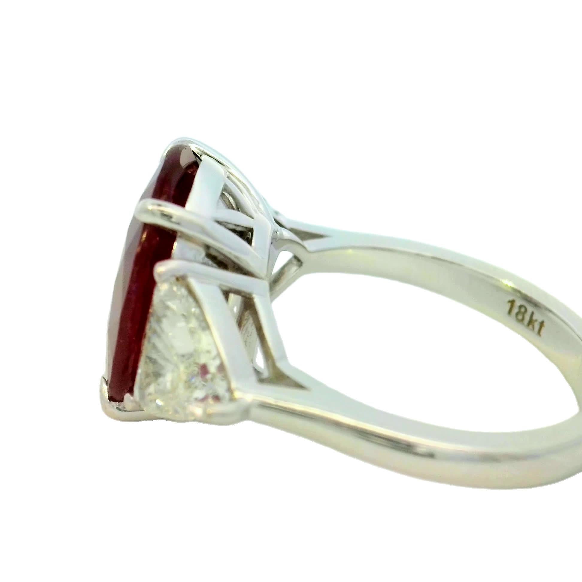 This exquisite ring features a captivating oval ruby at its center, flanked by two dazzling diamonds. The rich red hue of the ruby symbolizes passion and love, making it a perfect choice for special occasions. Crafted with precision, this piece is