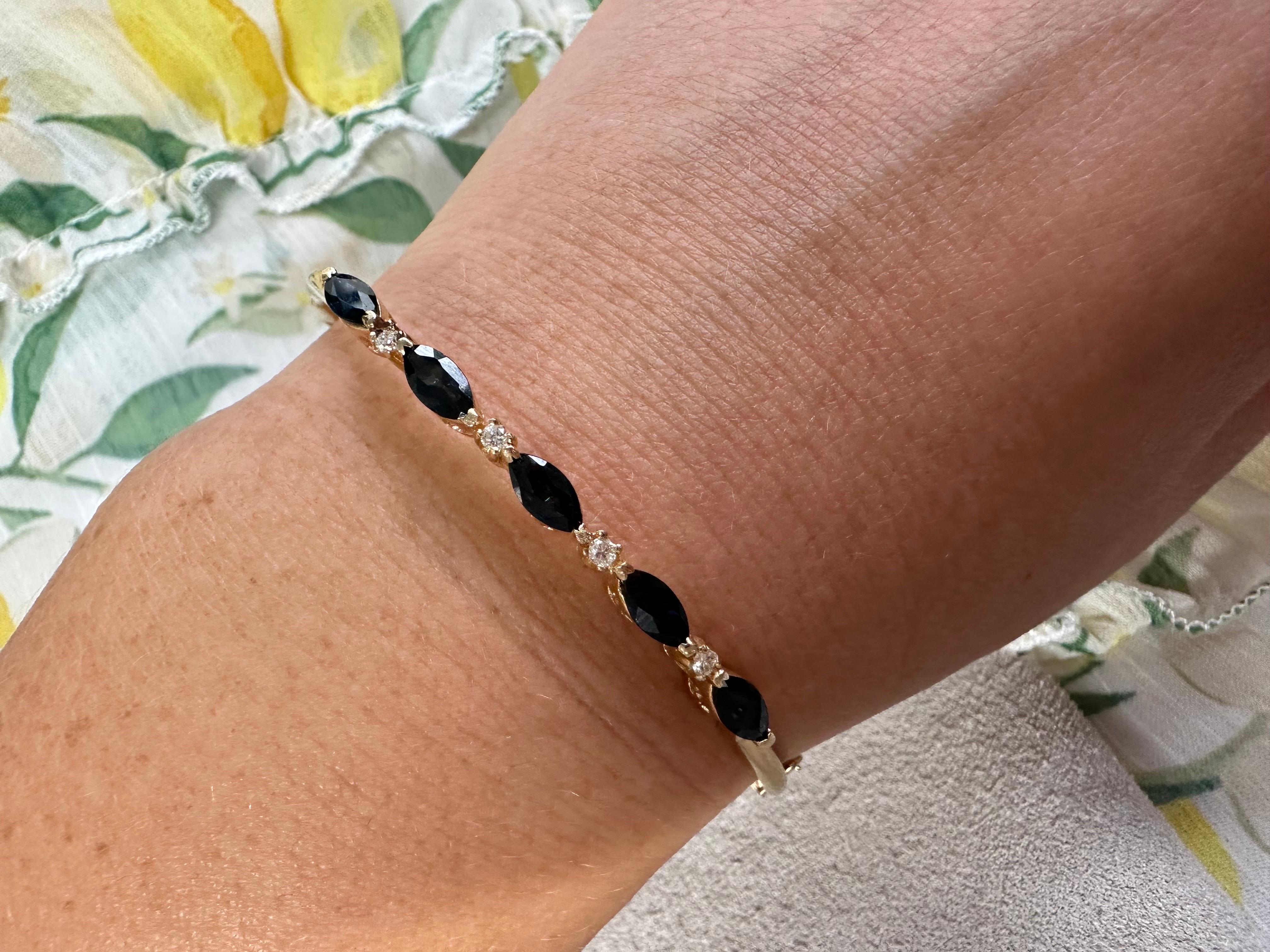 Solid 14KT bangle bracelet with security lock, made with dark sapphires and diamonds.

METAL: 14KT
Grams:6.70
Item24000009 aam

WHAT YOU GET AT STAMPAR JEWELERS:
Stampar Jewelers, located in the heart of Jupiter, Florida, is a custom jewelry store