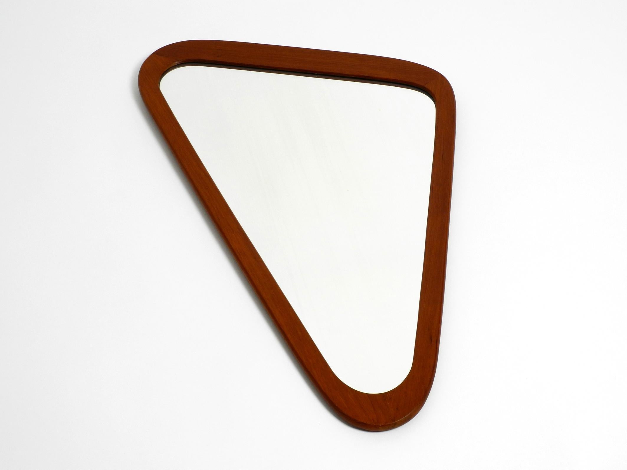 Stunning Scandinavian large midcentury teak wall mirror in an asymmetrical triangle shape.
Beautiful typical 1950s design.
High-quality workmanship in a minimalist Scandinavian design.
100% original condition. Very few signs of use.
With
