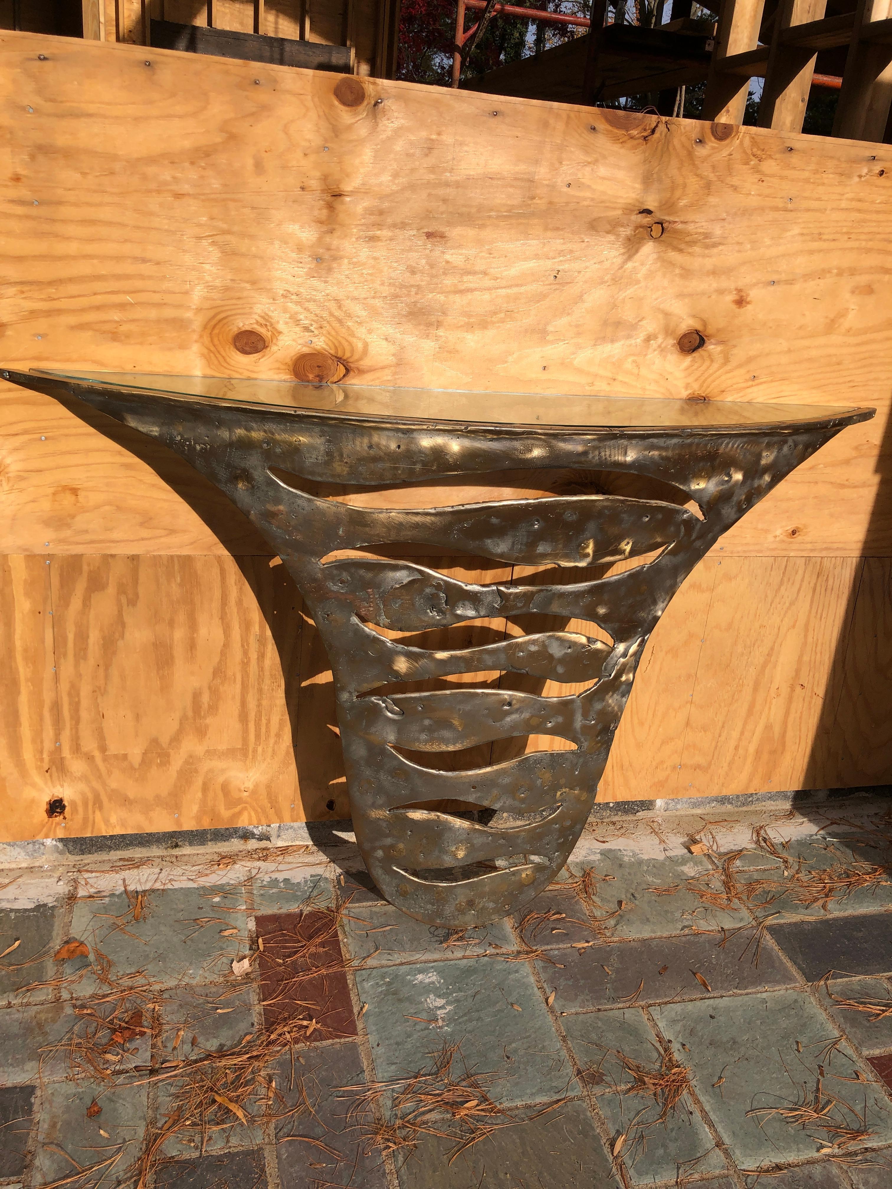 Stunning sculptural Silas Seandel attributed solid bronze brutalist demi-lune console table. This fabulous piece is hand wrought and torch cut in the brutalist style definitely made by a master.  It measures 35”t x 60”w x 11”d. 