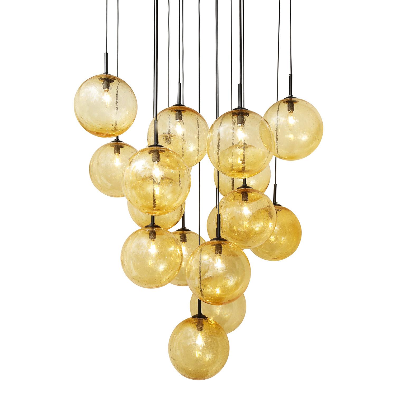 Hand-crafted amber, seeded glass globe chandelier with 16 pendants and blackened steel canopy. 



Customization of dimensions, finish and glass color available.

 