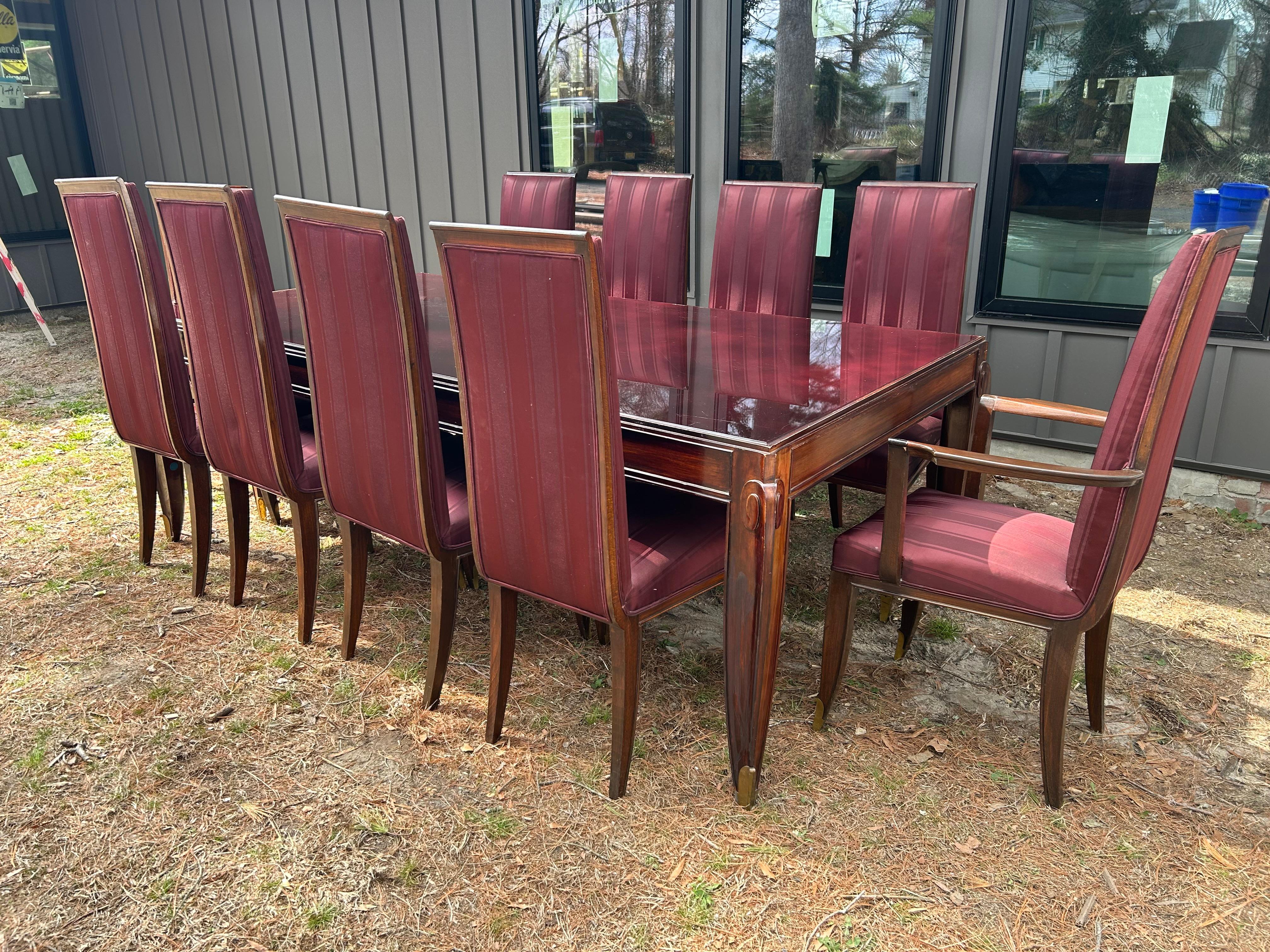 Stunning and important set of 10 Jean Pascaud Mahogany Dining Chairs.  This fine set was purchased at Sotheby's auction back in the 80's and is exquisite in person.  We have the matching table listed separately as seen in the photos.  The