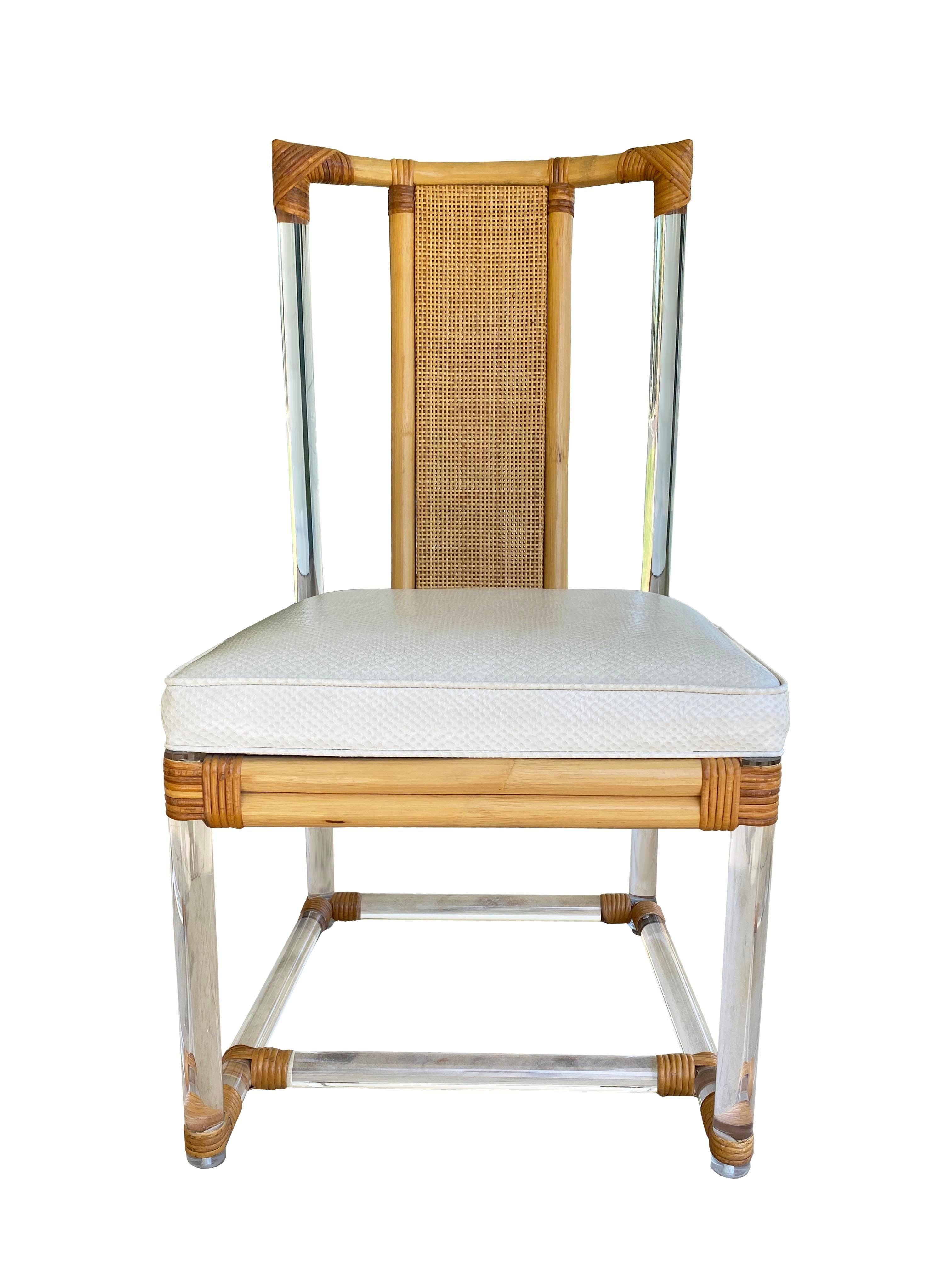 A stylish set of three vintage chairs, blending rattan, bamboo, and lucite for a look that’s both natural and modern. These striking chairs feature clear lucite frames that provide a light, airy feel, while the bamboo and rattan accents bring in