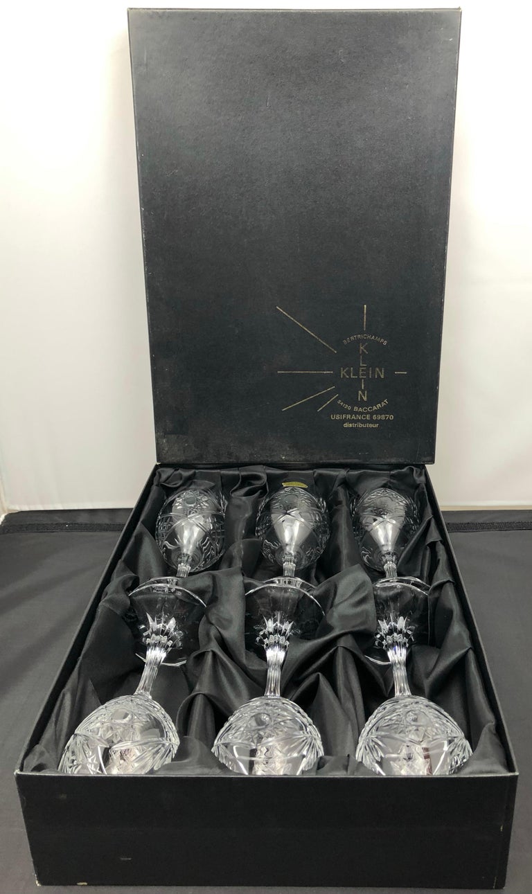 A truly elegant vintage crystal service set by Baccarat comprised of six red wine glasses with extraordinary hand-cut details, France, circa 1940. Each glass bears the Baccarat mark and references the name of the designer, Valery Klein. 

These