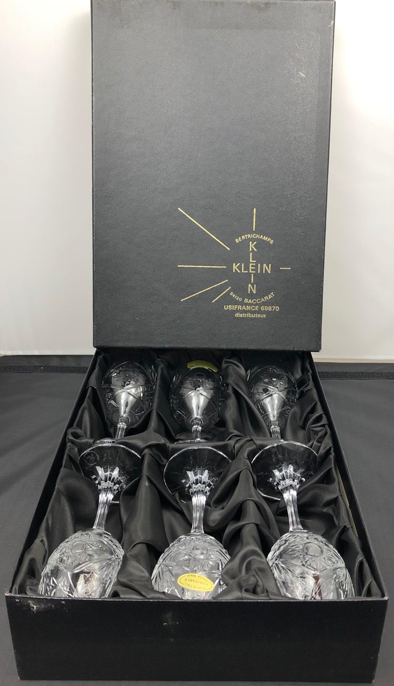 A truly elegant vintage crystal service set by Baccarat comprised of six white wine glasses with extraordinary hand-cut details, France, circa 1940. Each glass bears the Baccarat mark and references the name of the designer, Valery Klein. 

These
