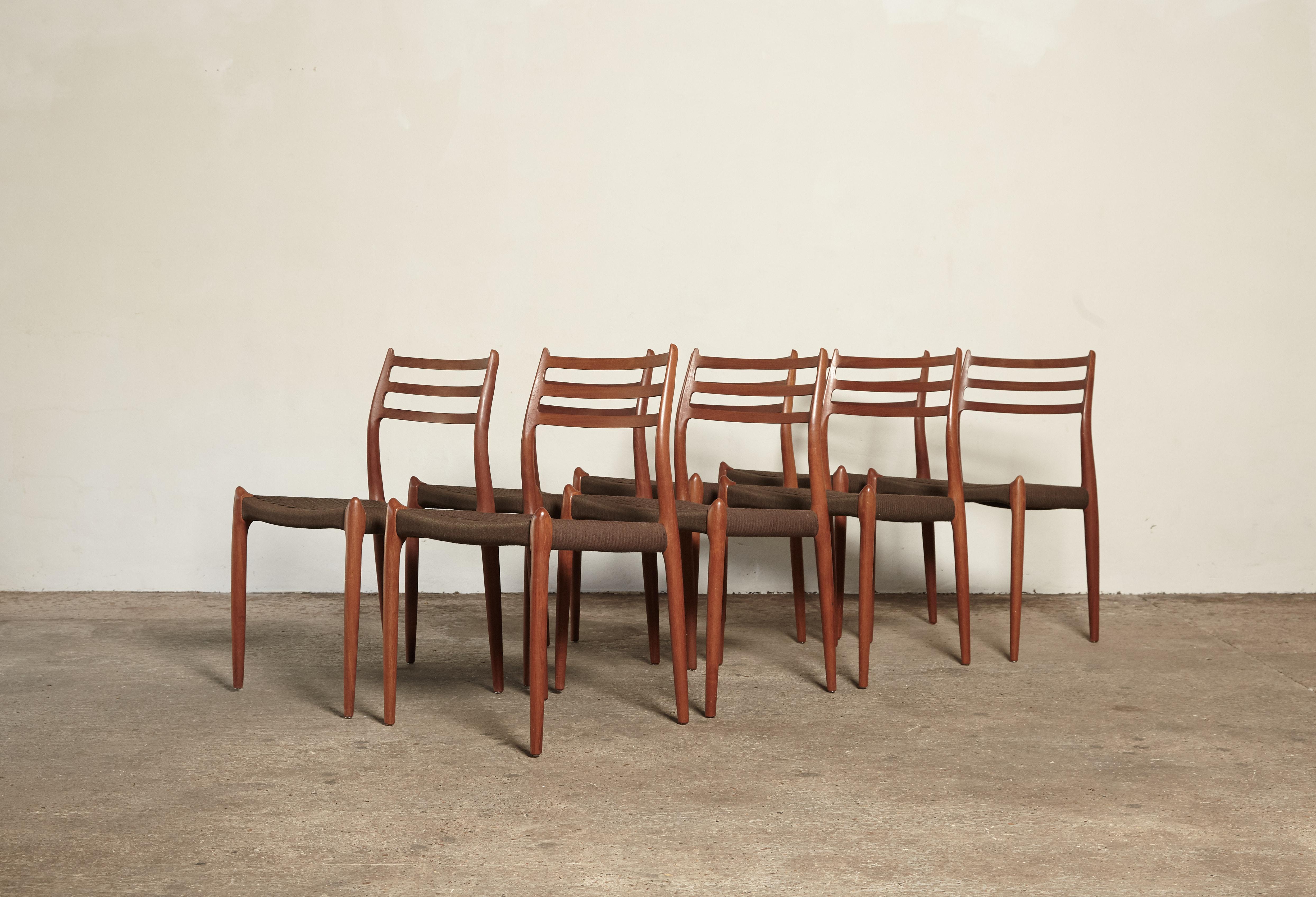 A stunning set of 8 Niels O Møller model #78 teak dining chairs, Denmark, 1960s in excellent condition. Produced by J.L. Moller Mobelfabrik in Denmark and stamped with makers mark.  Original, and extremely rare, woven brown ribbon seats.   Ships