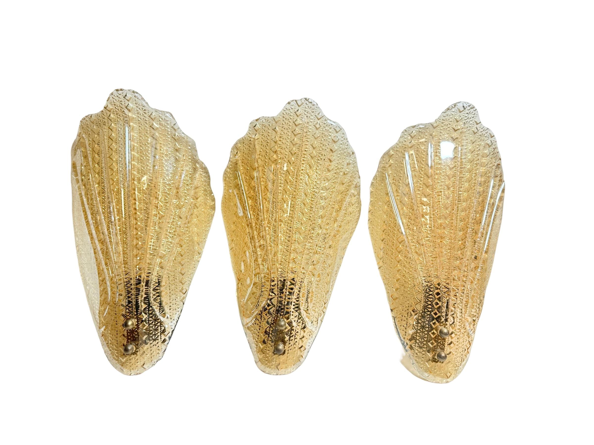 Incredible mid century Murano glass leaf wall sconce with heavy brass fixture. This wonderful piece was designed in Italy by Barovier & Toso during the 1960s.
Each sconce is outstanding as the way the leaf is designed in detail on the edges and
