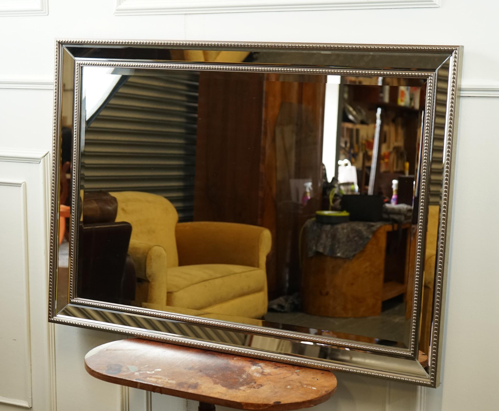 Antiques of London



We are delighted to offer for sale this Stunning Silver Bevelled With Silver Beads Mirror.

A modern bevelled mirror with silver beads going around the frame in a straight line is a contemporary and stylish piece that adds a