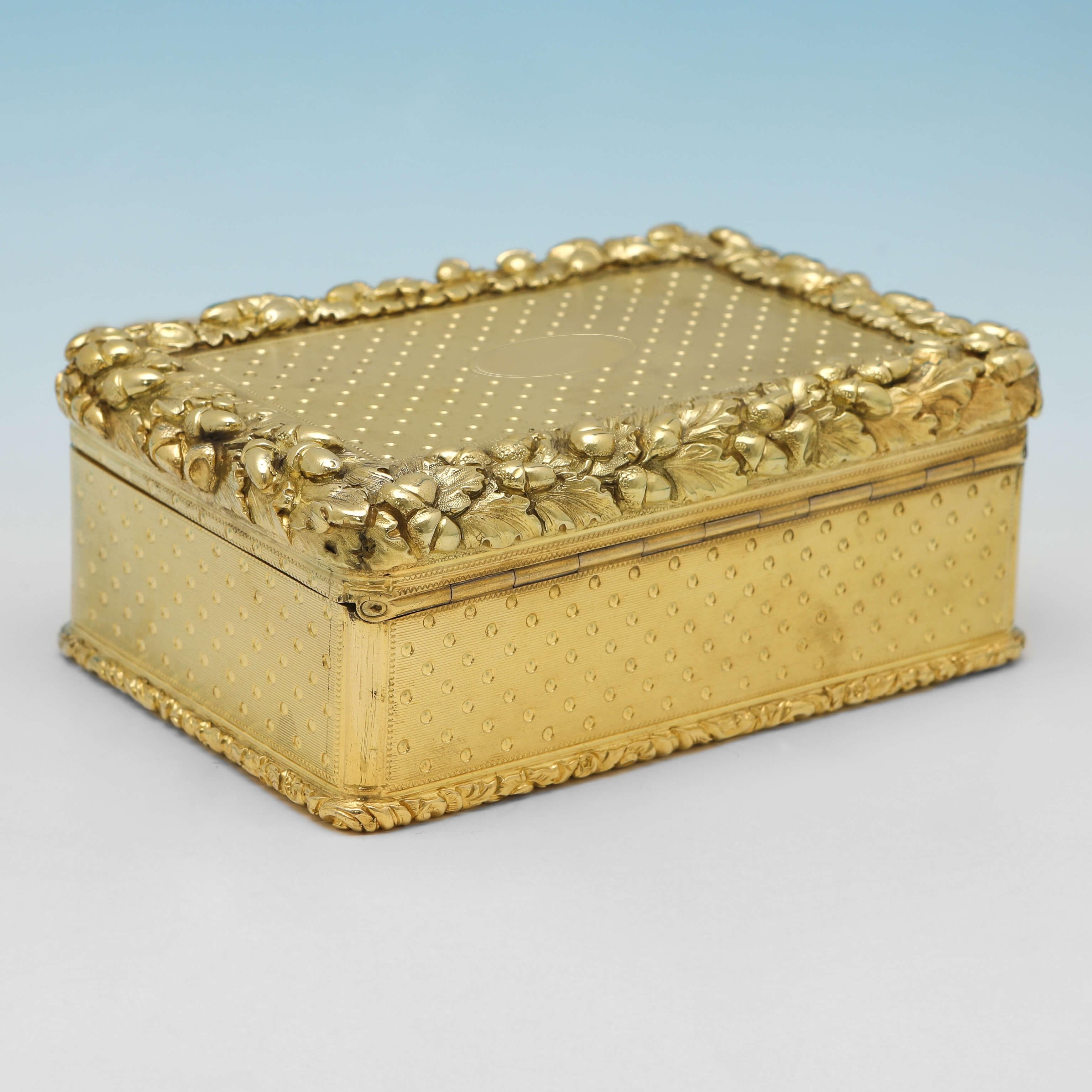 Hallmarked in London in 1853 by Thomas Edwards, this very handsome, Victorian, Antique Sterling Silver Snuff Box, features engine turned decoration, a cast border with acorn detailing, and original gilding. 

The snuff box measures 1.75