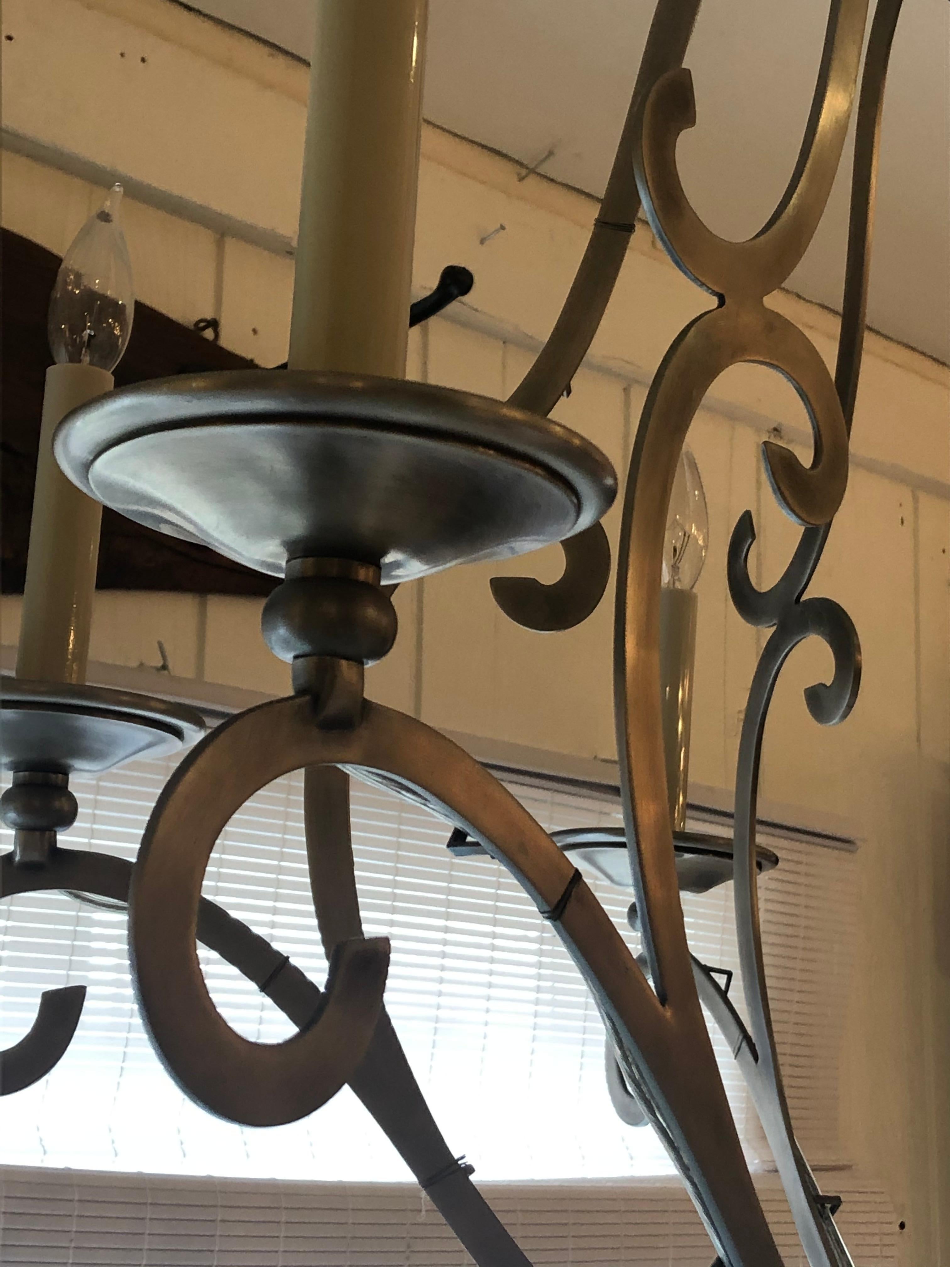 Great looking contemporary traditional silver metal chandelier having lovely sleek curlicues.
32