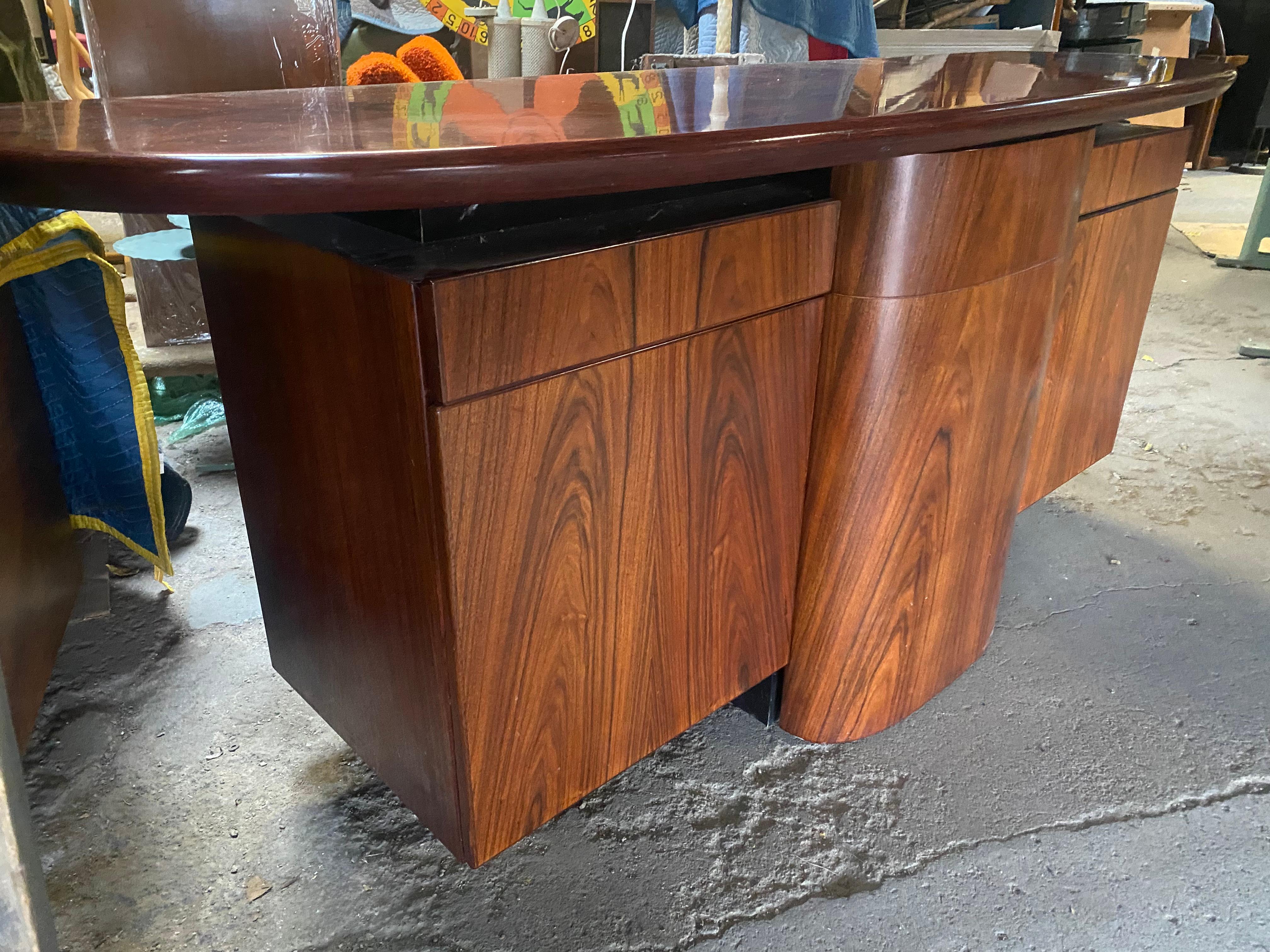 Stunning rosewood sideboard / dry-bar by Skovby Mobelfabrik, Amazing original condition, Gorgeoeus book-match richly grained rosewood. This unit features a sleek design with plenty of storage.. What's unique about this credenza is that the center