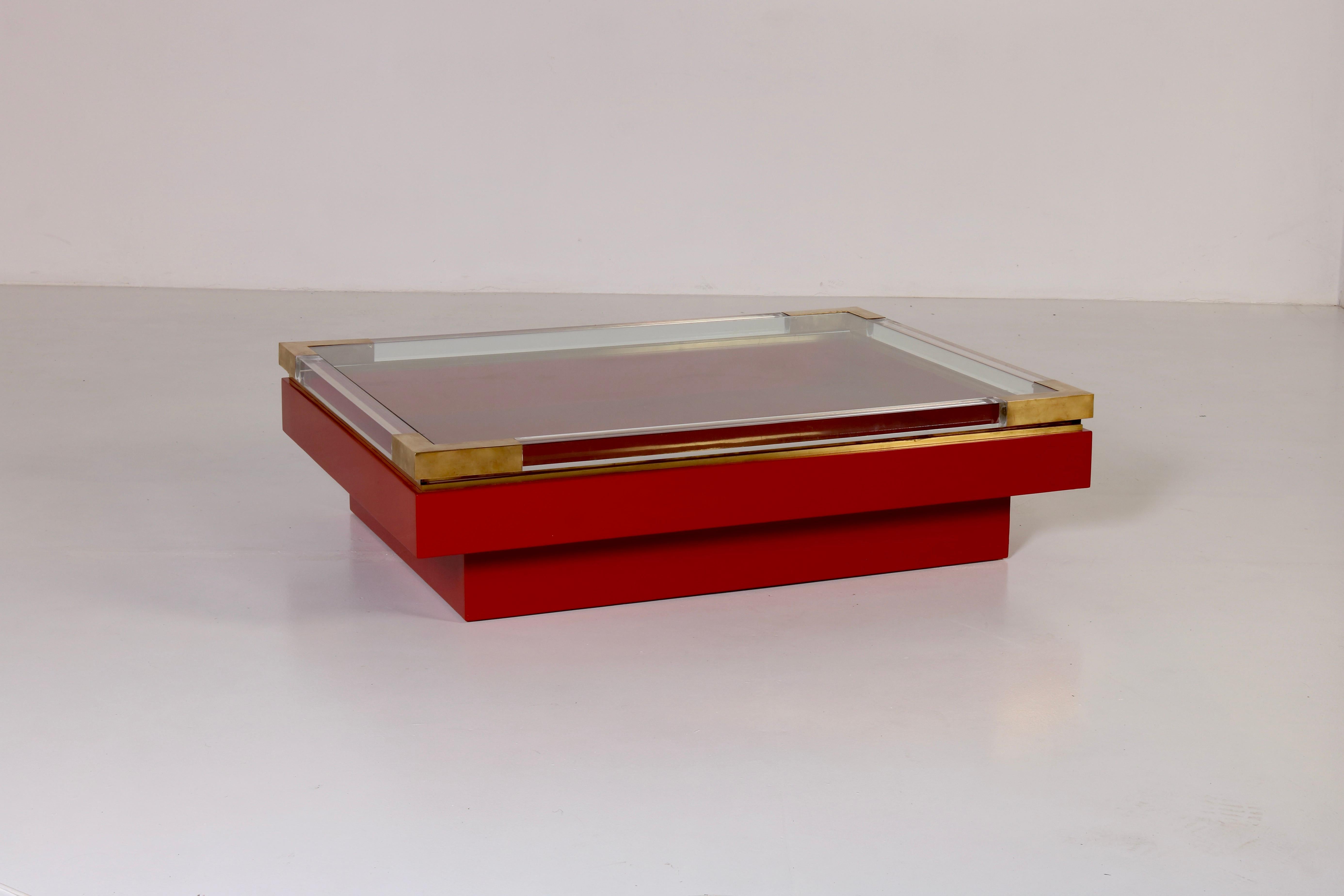 
This stunning sliding top low table in red and gold by Romeo Rega represents an unforgettable masterpiece. The juxtaposition of rich colors and metallic accents with the transparencies of both plexiglass frame and glass top, makes it an unique
