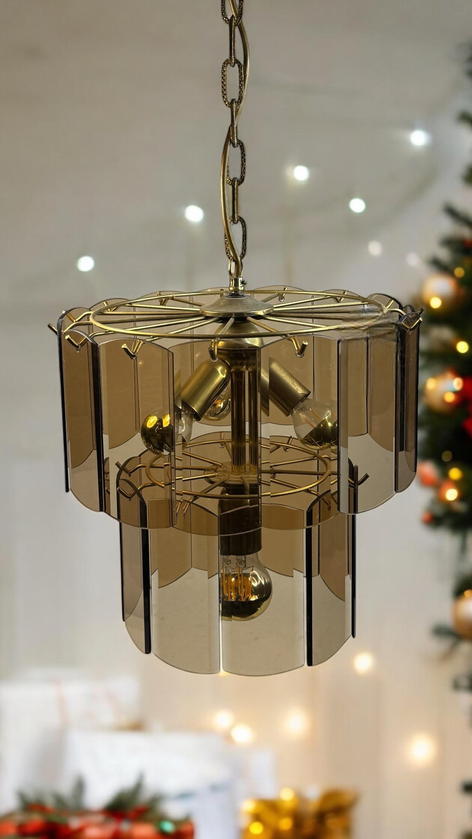 Stunning exceptional glass chandelier. Made in Germany, circa 1970s by the famous Massive Lighting Leuchten Company. The Chandelier requires three European E14 candelabra bulbs, each up to 40 watts and one E27 bulb with up to 60 Watts in the middle.