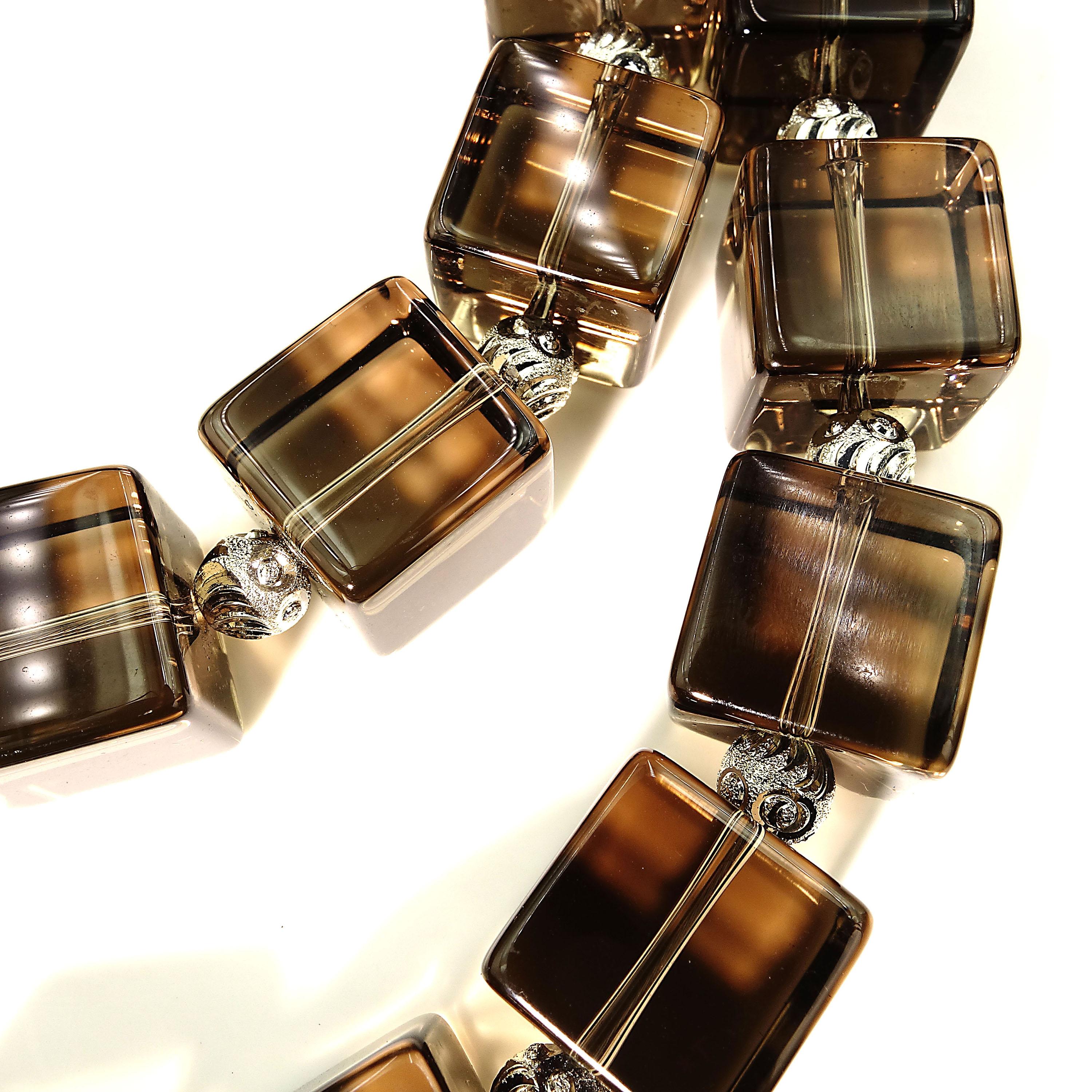 This is a Statement Necklace of Glowing, Clean Cubes (14x14mm) of Smoky Quartz enhanced with etched silver tone spacers (6mm).  The clasp is also silver tone with complementary druzy inset.  The Smoky Quartz is extraordinary, it is so clean and