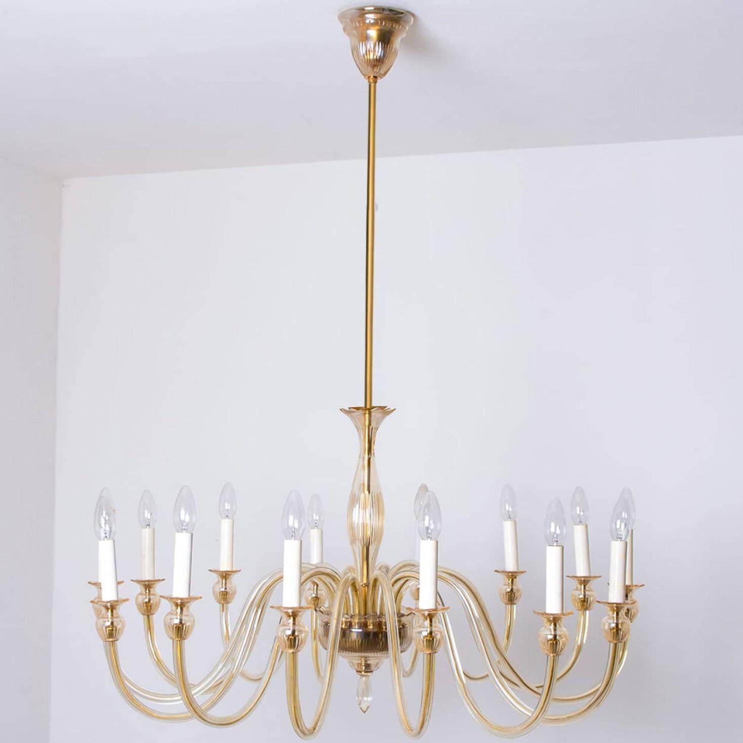 Beautiful 14 arms hand blown Murano glass chandelier, Italy 1960.

The warm amber glass exudes a rich, inviting glow, while the elegant design and craftsmanship make it a stunning focal point in any room. A timeless addition to your decor, this