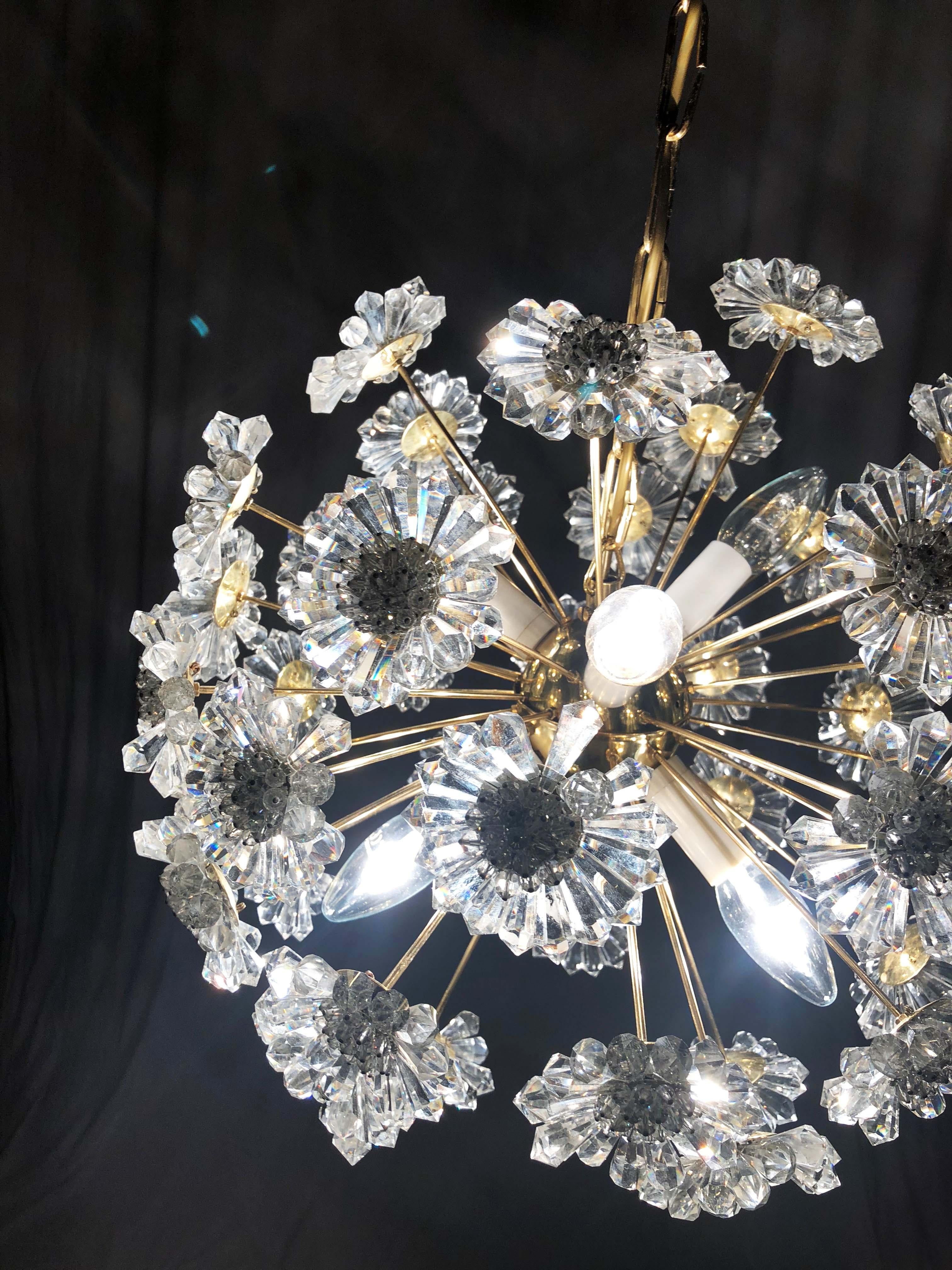 Brass frame with brass arms and glass daisy flowers on the ends. Fitted with six E14 sockets up to 40W each (nowadays LED).
This chandelier was made by Preciosa in Jablonec in the Czech Republic in the 1970s.
The total height is now 65cm but it