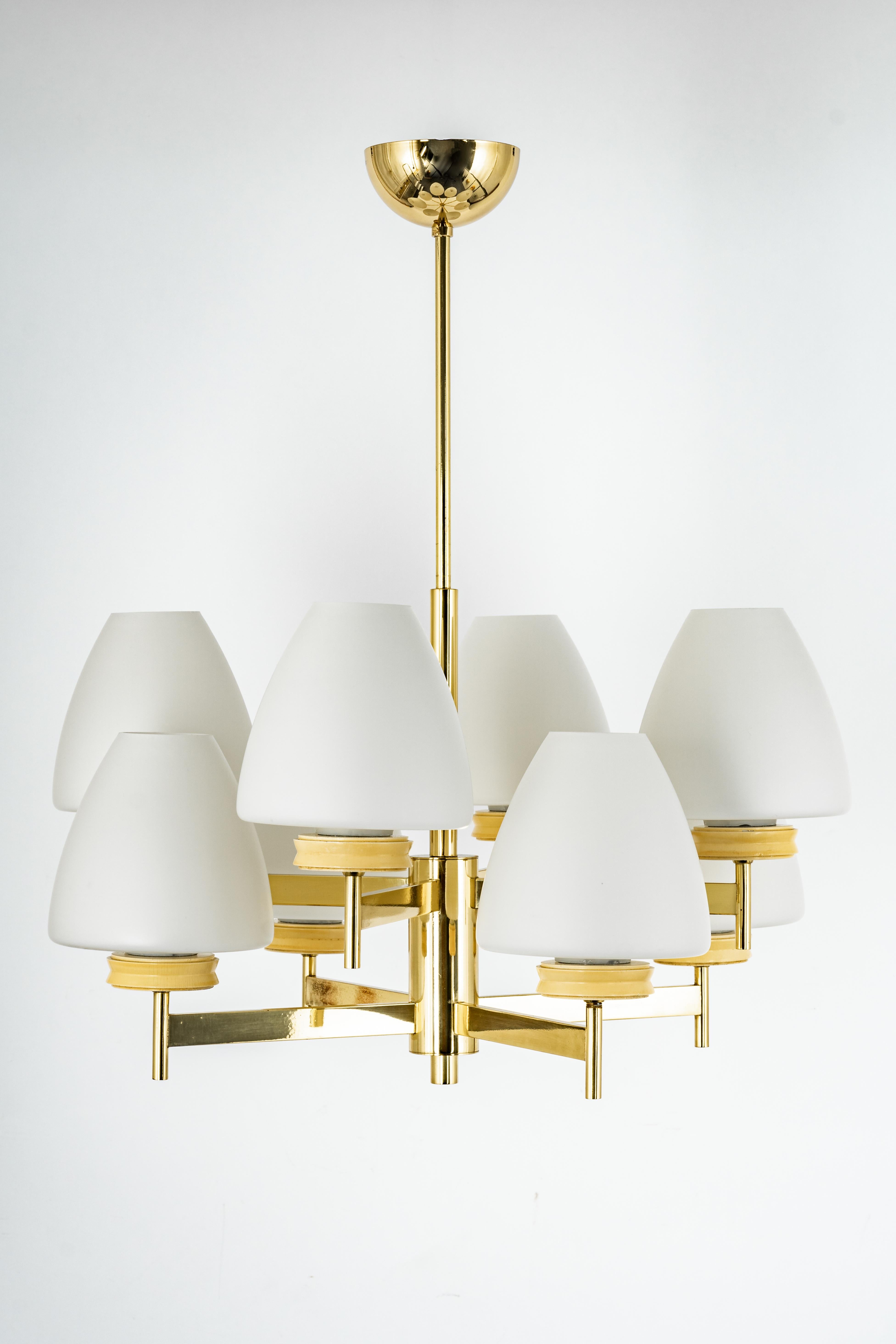Stunning Sputnik brass chandelier with eight opal glass globes by Kaiser Leuchten, Germany, 1960s.

Heavy quality and in very good condition. Cleaned, well-wired and ready to use. 

The fixture requires 8x E14 small bulbs with 40W max