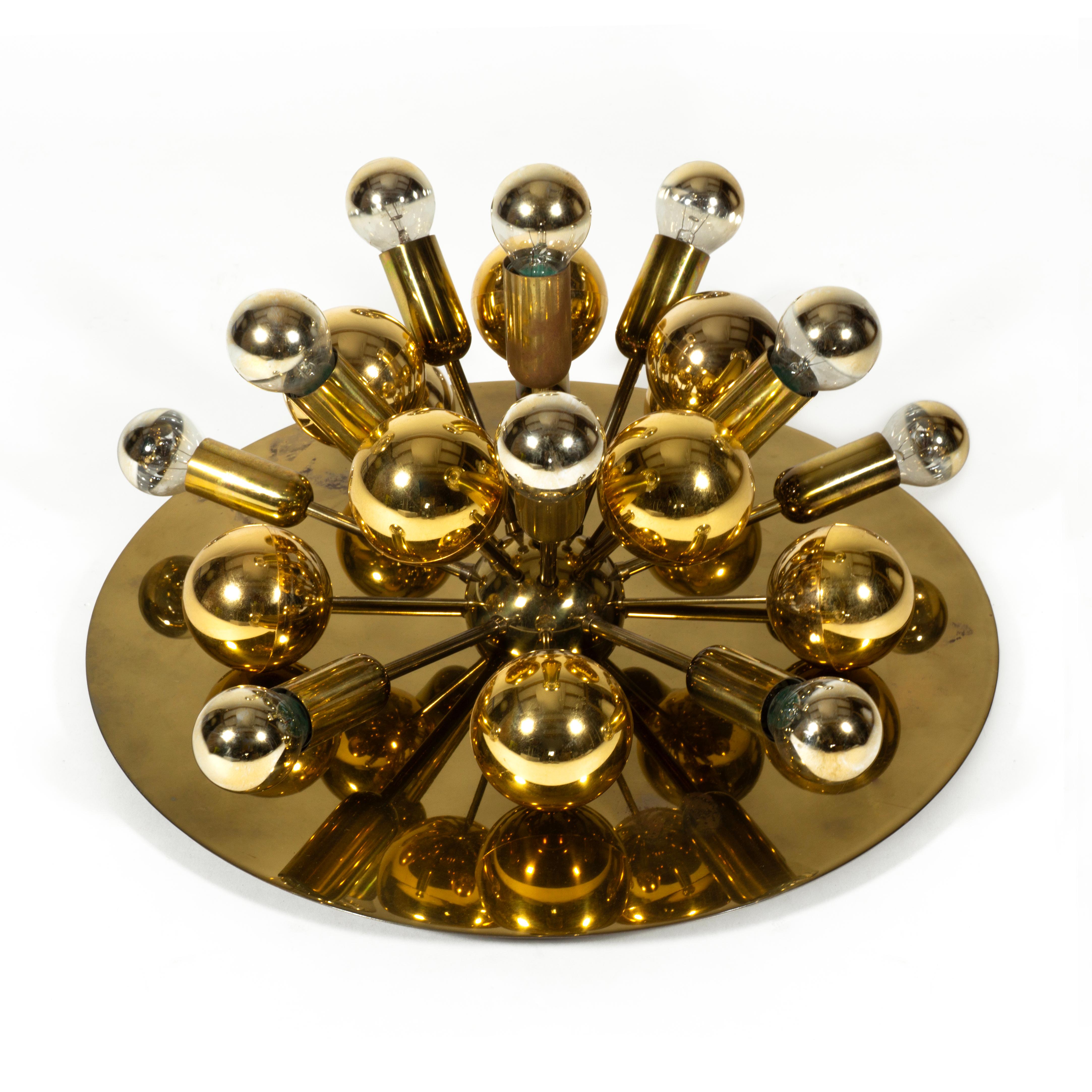 Very stylish and eye-catching Sputnik Atomic wall or ceiling light by Cosack from the 1970s. 
The lamp has 11 light sources and 10 golden plastic spheres, which refract the light wonderfully and allows the luminaire to shine in all its splendor.