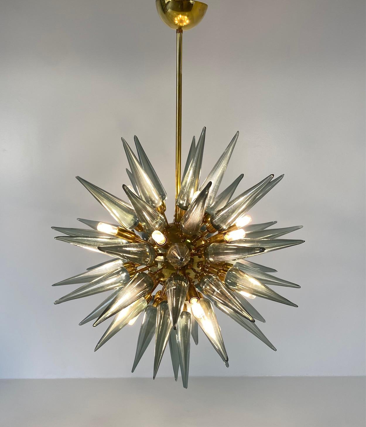 This stunning chandelier was produced in Italy, more precisely in Murano, the world's capital of the art of glass making and crafting. 

This chandelier is in the classic but never out of fashion, 'Sputnik' style, or rather the design born in the