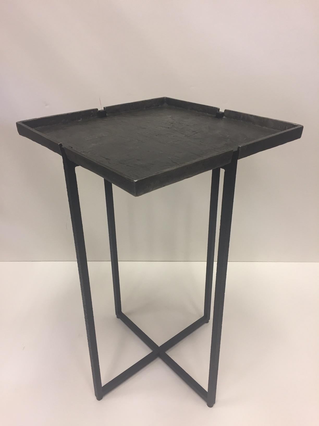 Iron and cast aluminum occasional table having handsome removable square top and elegant criss cross base. Label Michael Aram underneath.