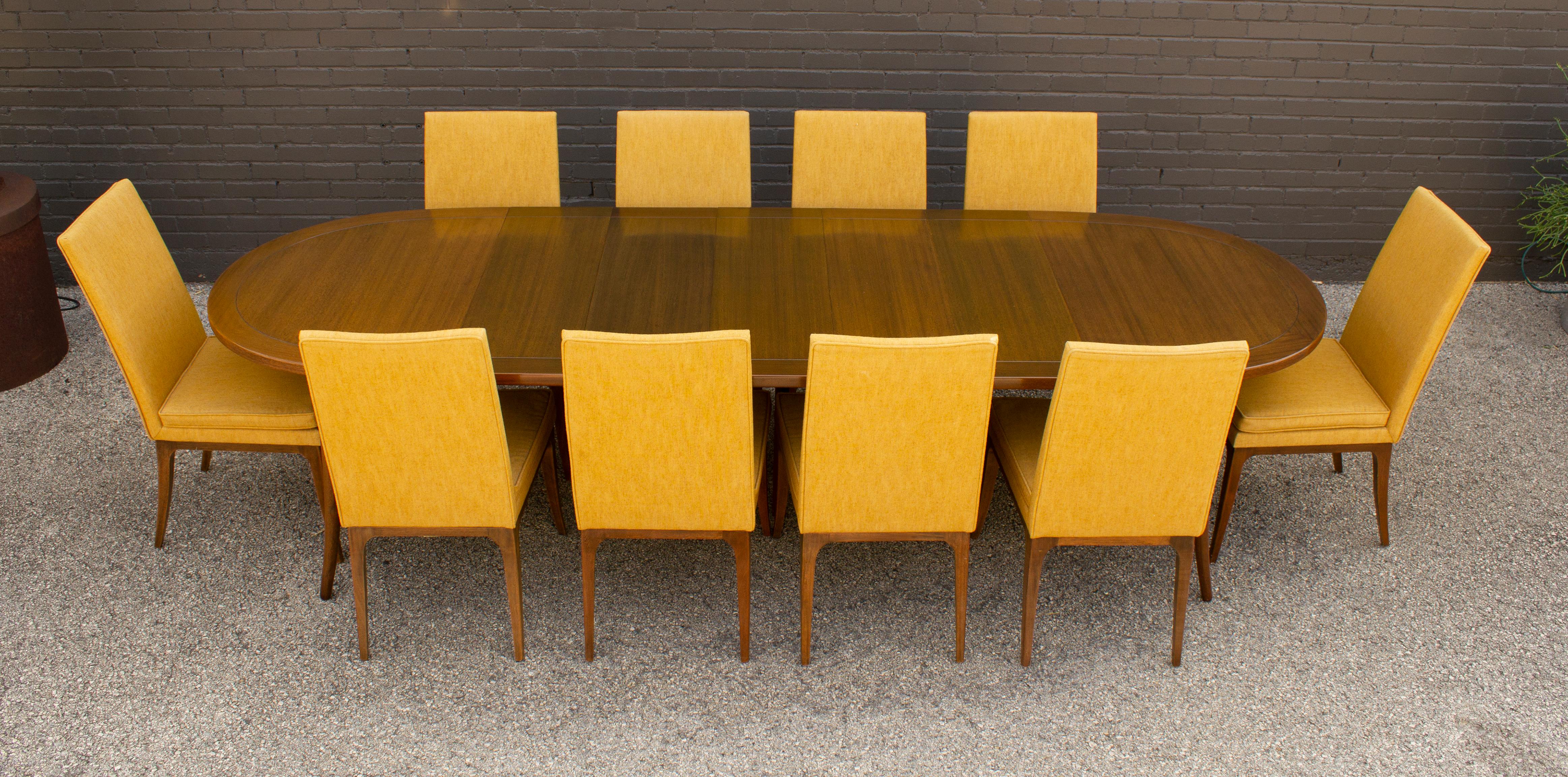 Stunning 10 foot long dining set designed by Harvey Probber. Set consists of an extension dining table with beautiful sabre legs and 5 matching leaves. The table measures 56