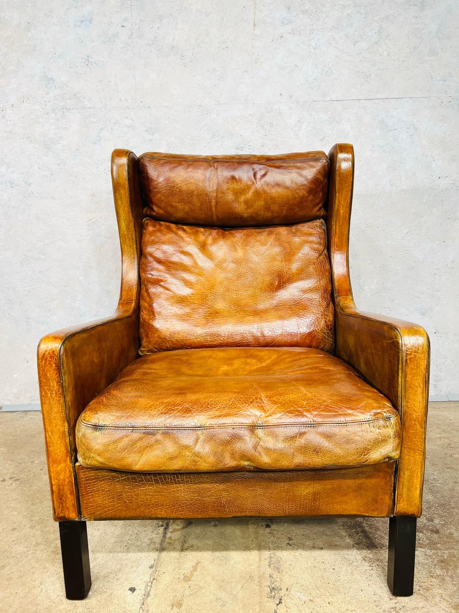 A Stunning Vintage Danish 1970s Wingback armchair by designer Thams Kvalitet, great quality chair, with a beautiful shape and proportions. Sits beautifully. In great condition with a great patinated tan colour.

The leather is great quality and