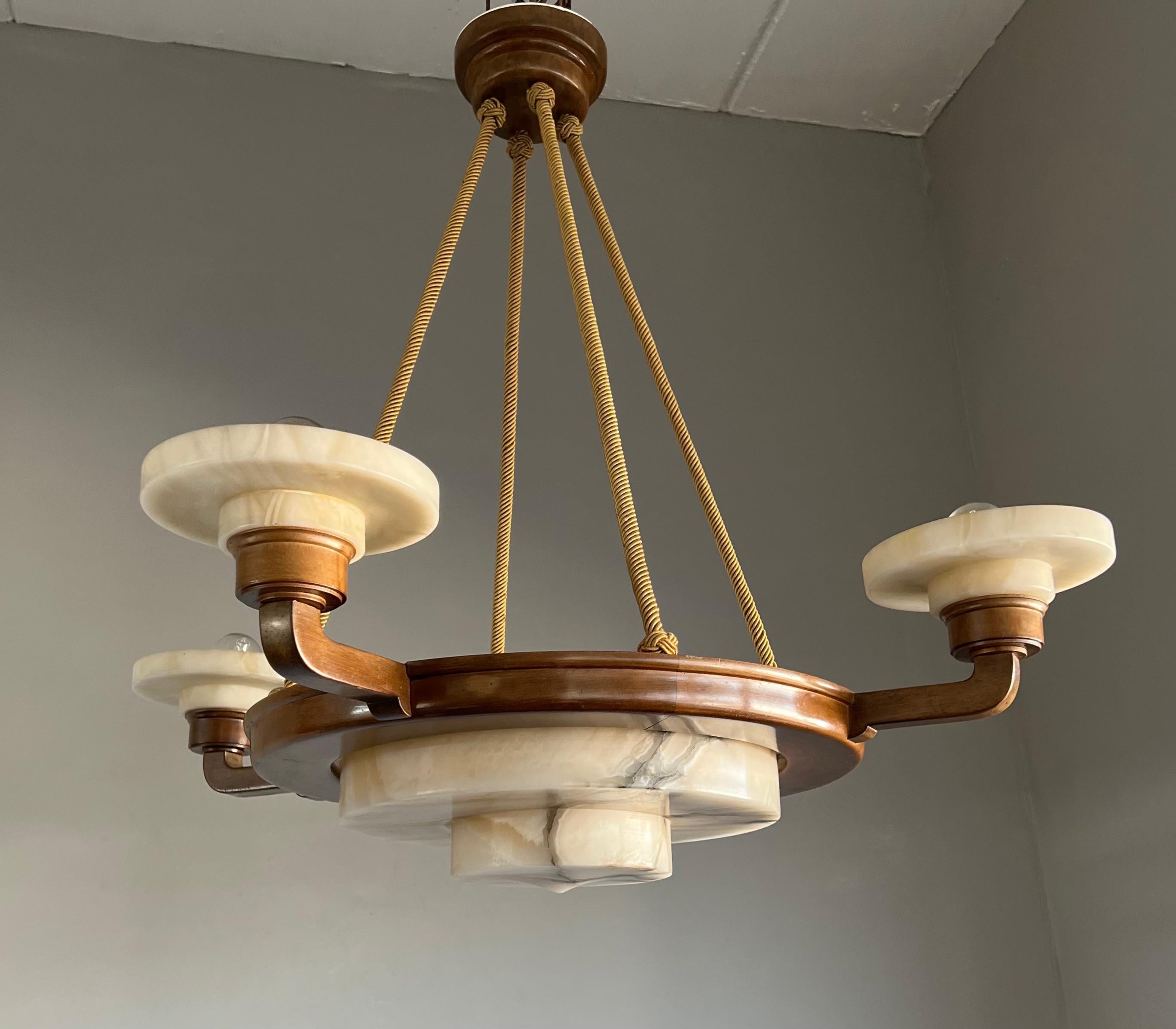 One of the kind/best Art Deco pendant lights ever with a unique design and presence.
 
This stunning, early 20th century, alabaster pendant with its rare 'circular-angular' design is in perfectly original and very good condition. The circular yet