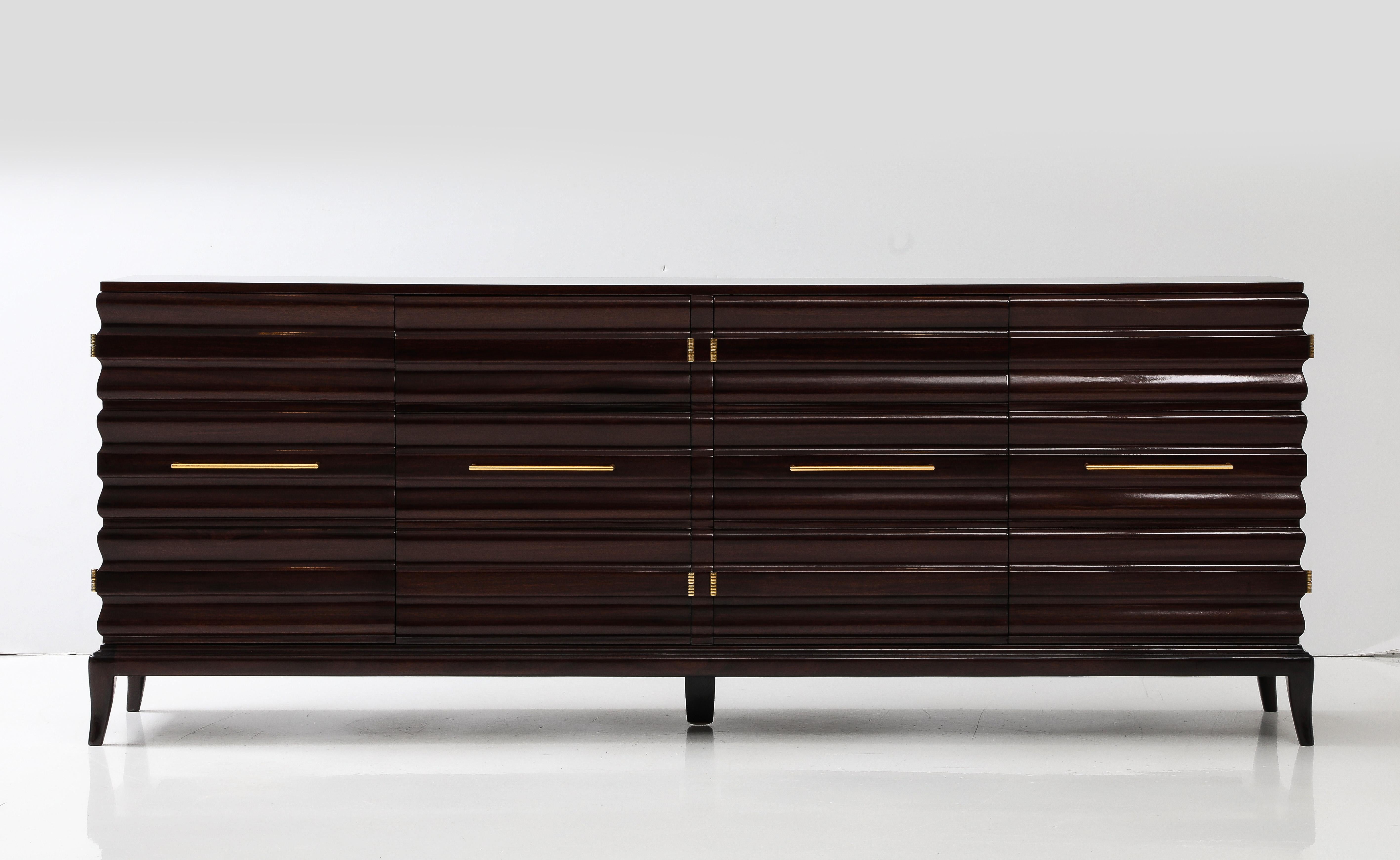 Stunning Wave front cabinet by Tommi Parzinger.
The  two double door cabinet has been Newly restored  with polished brass handles.
The interior of the cabinet has four adjustable shelves.