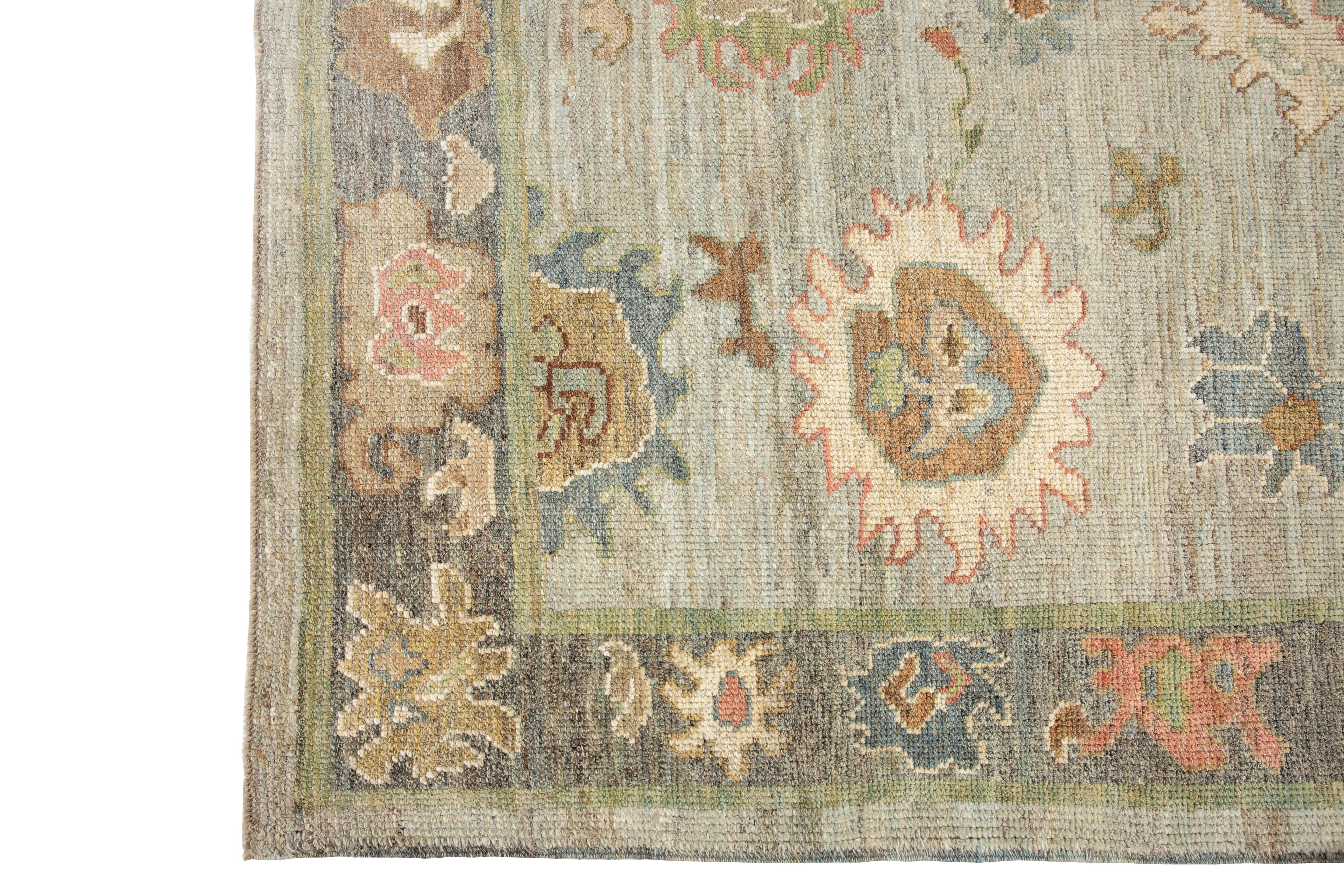 Introducing our handmade Oushak rug, a stunning piece of Turkish craftsmanship that will elevate any room in your home. With a light blue background and a distinct grey border, this rug is both traditional and contemporary. The intricate design