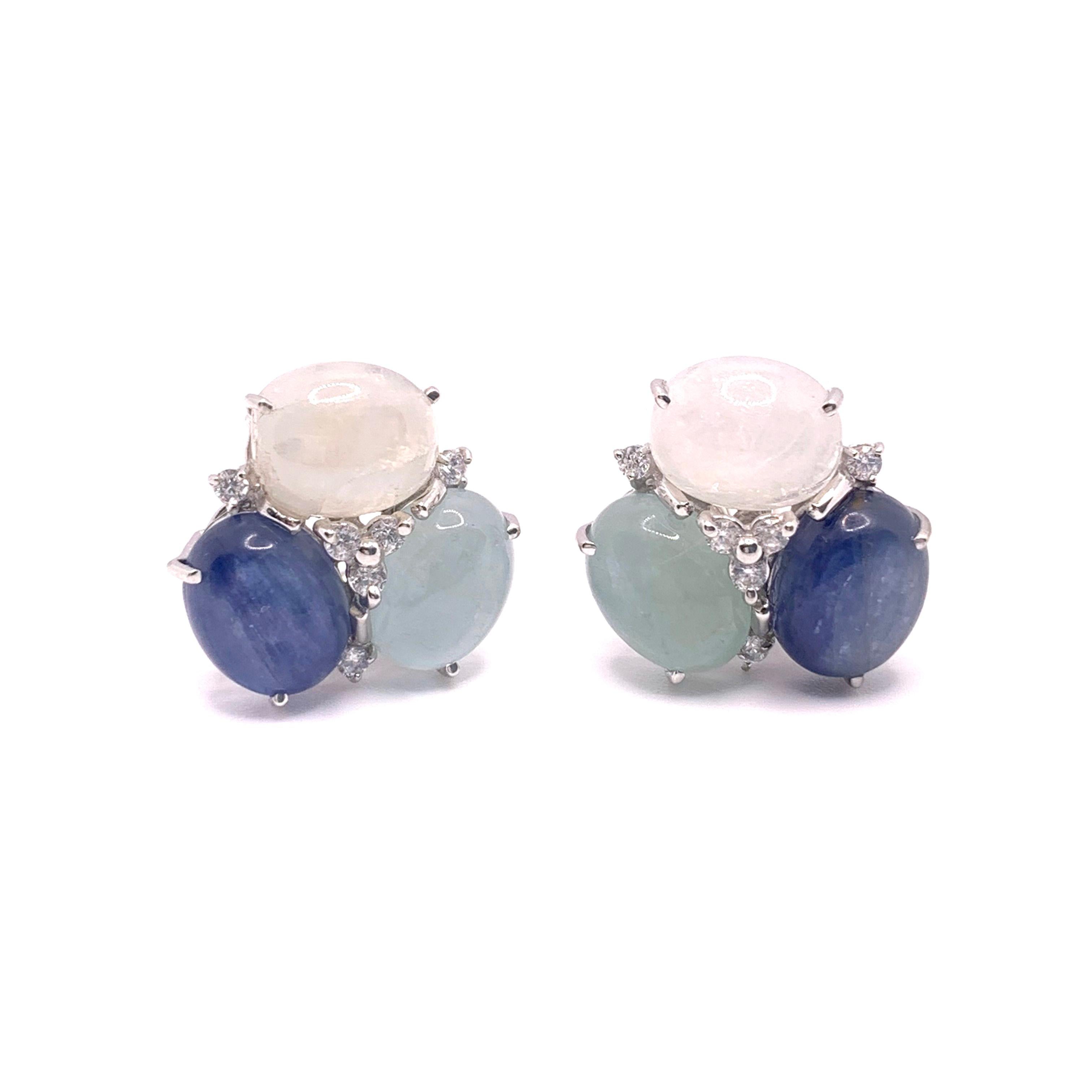 These stunning pair of earrings feature sets of oval cabochon-cut aquamarine, kyanite, and rainbow moonstone, adorned with round simulated diamonds, handset in platinum rhodium plated sterling silver. The combination of these three color stones are