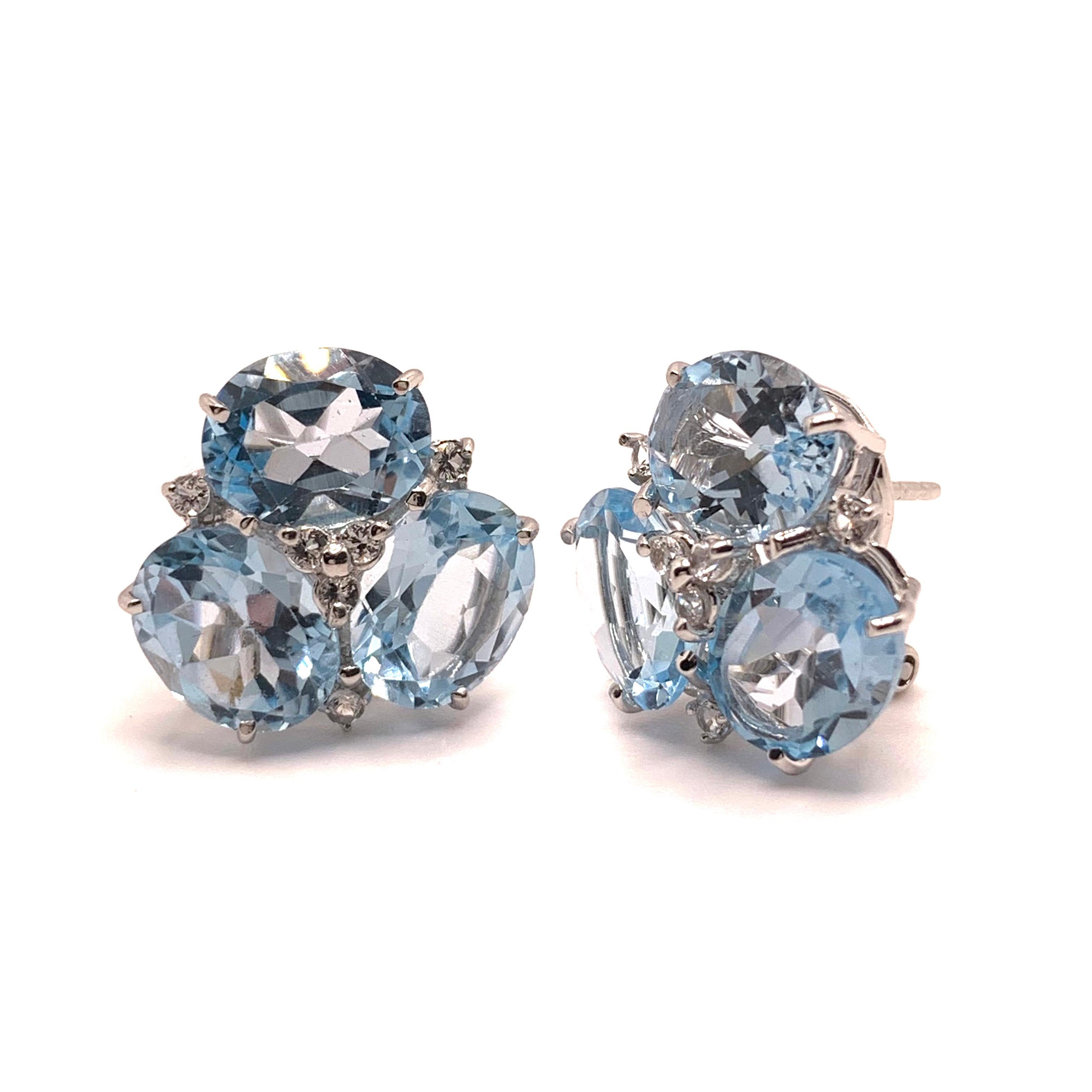 These stunning pair of earrings feature sets of oval genuine sky blue topaz adorned with round white topaz, handset in platinum rhodium plated sterling silver. We love the soft blue topaz color - look like aquamarine and produce beautiful shiny