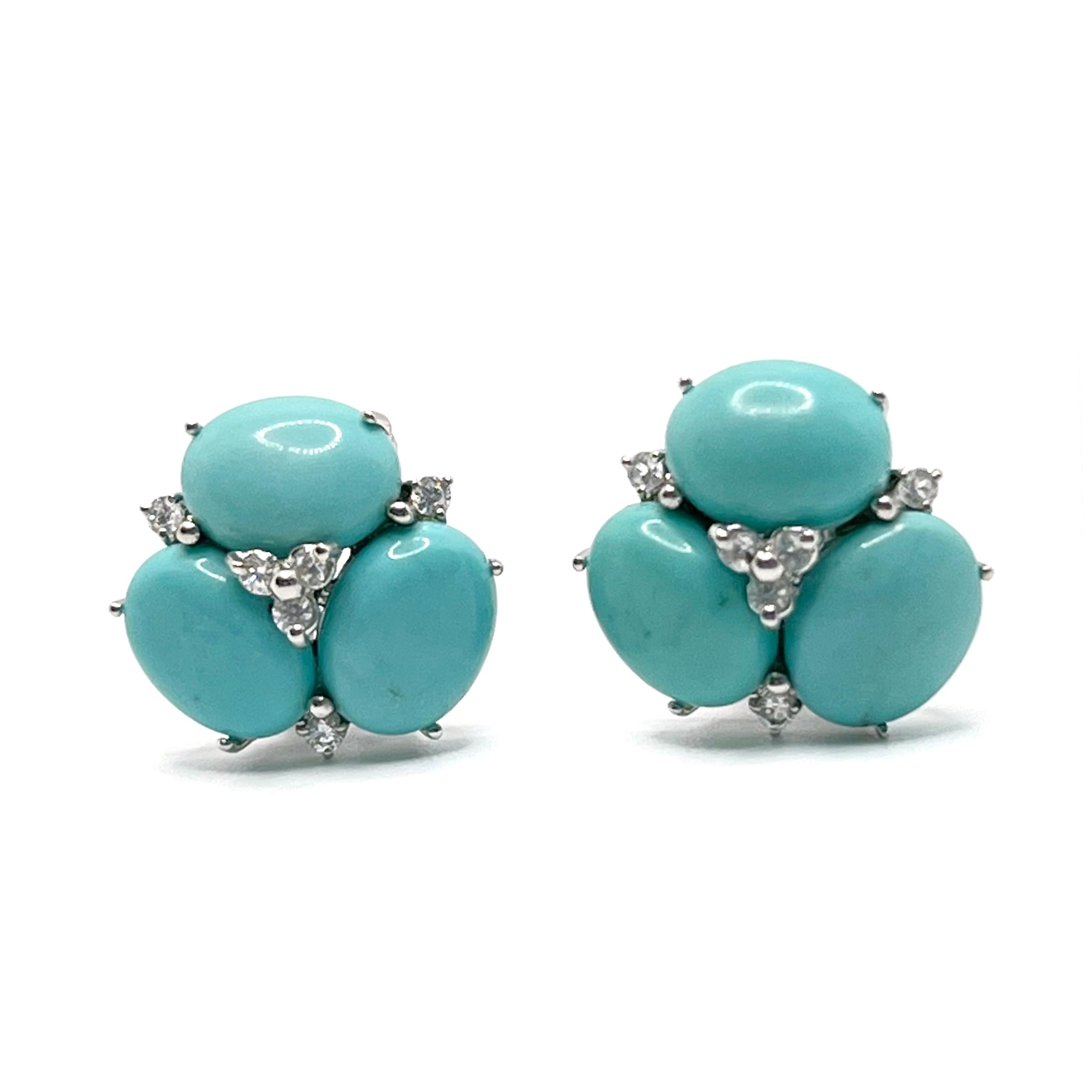 These stunning pair of earrings feature sets of oval cabochon-cut turquoise adorned with round simulated diamonds, handset in platinum rhodium plated sterling silver. The turquoise stones have natural blue-green hue - a striking color that looks so