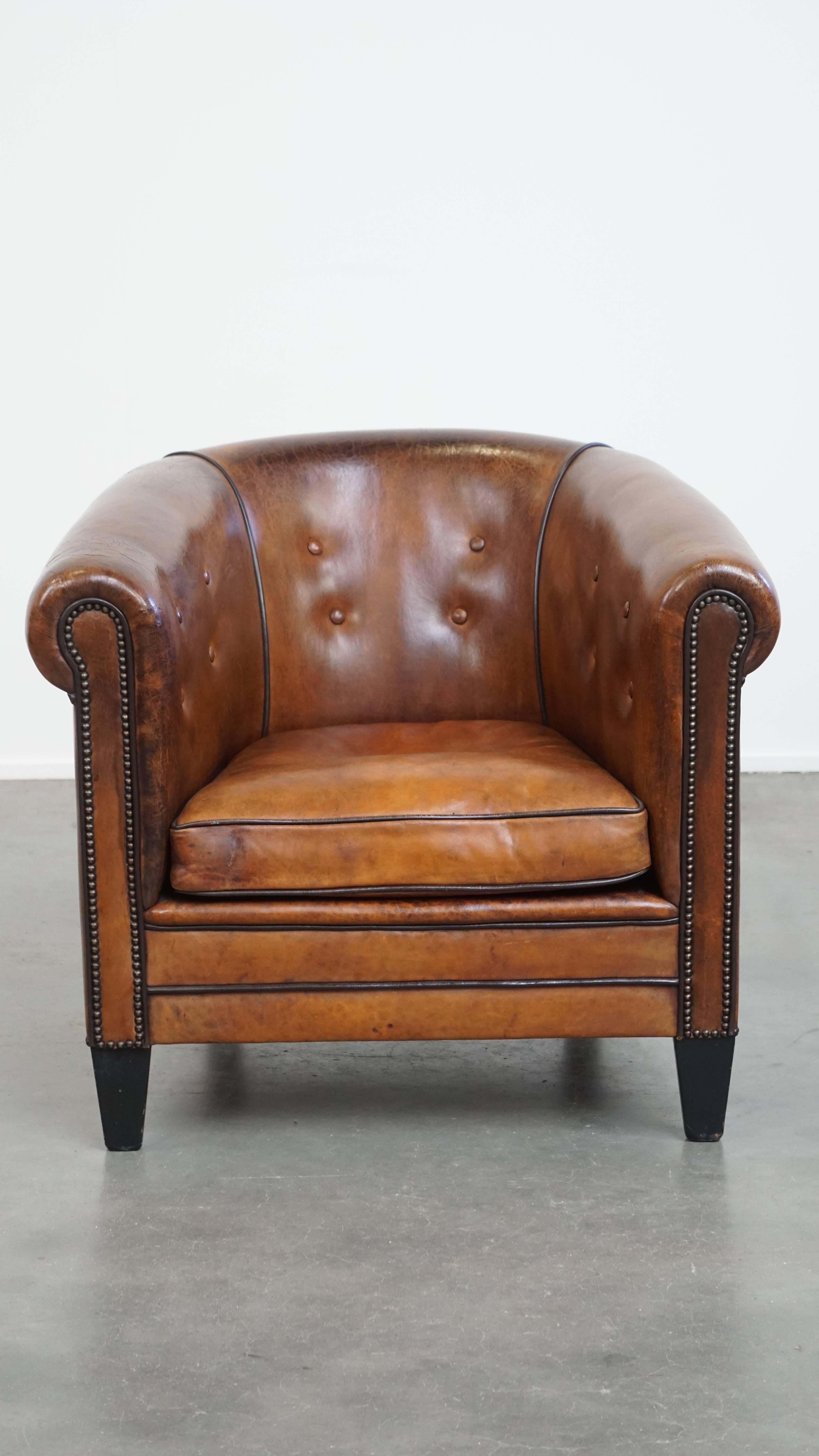 This gorgeous sheepskin leather club armchair stands out thanks to its remarkable details and unique character. It features luxurious finishes, including decorative studs and black piping, giving it a refined and elegant look.

The armchair comes