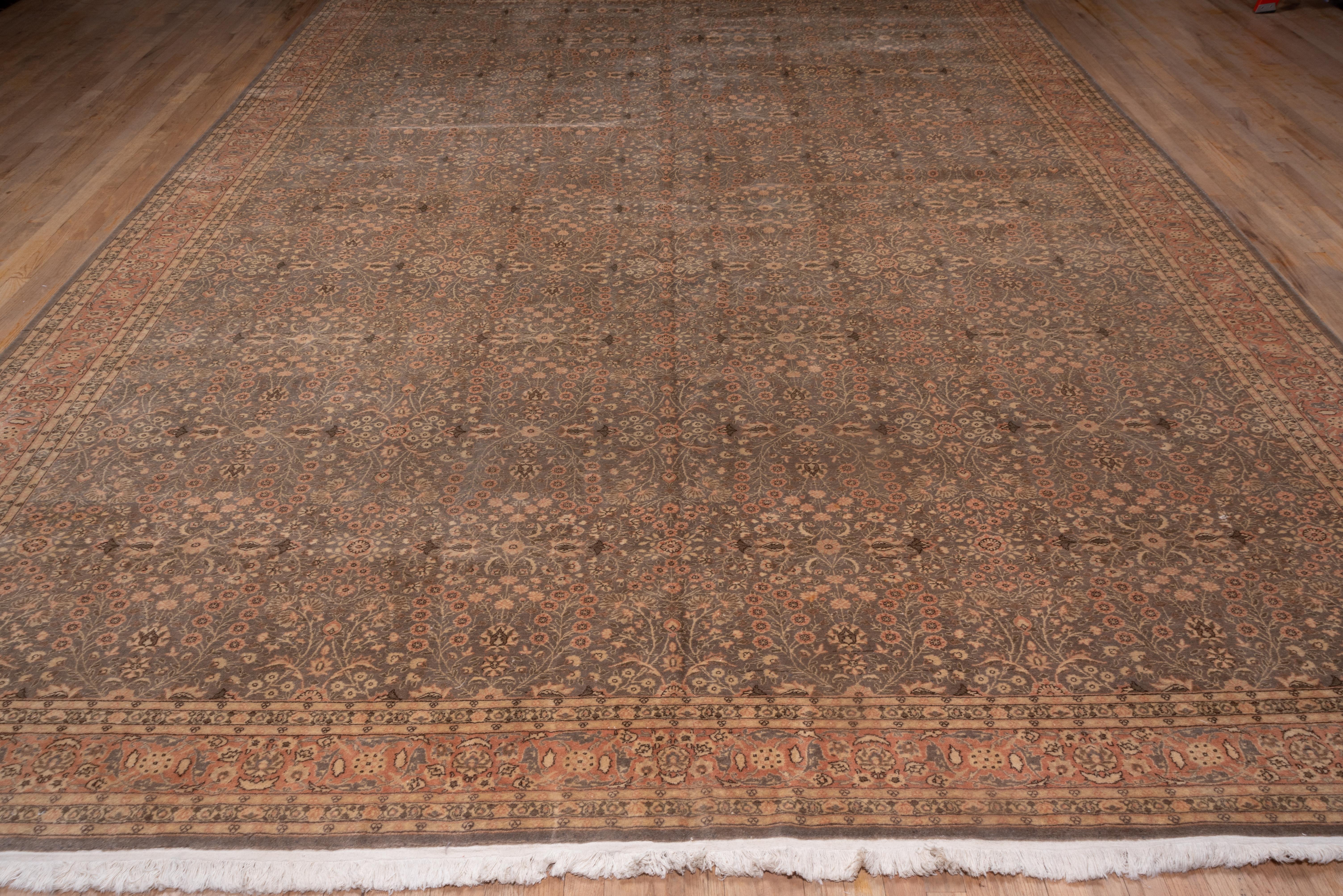 This NW Turkish city carpet is finely and evenly woven, with a short, resilient pile in a repeating small-scale floral all-over pattern on the green field. The palette is light with accent tones of straw, sand, dark brown, green and buff. The