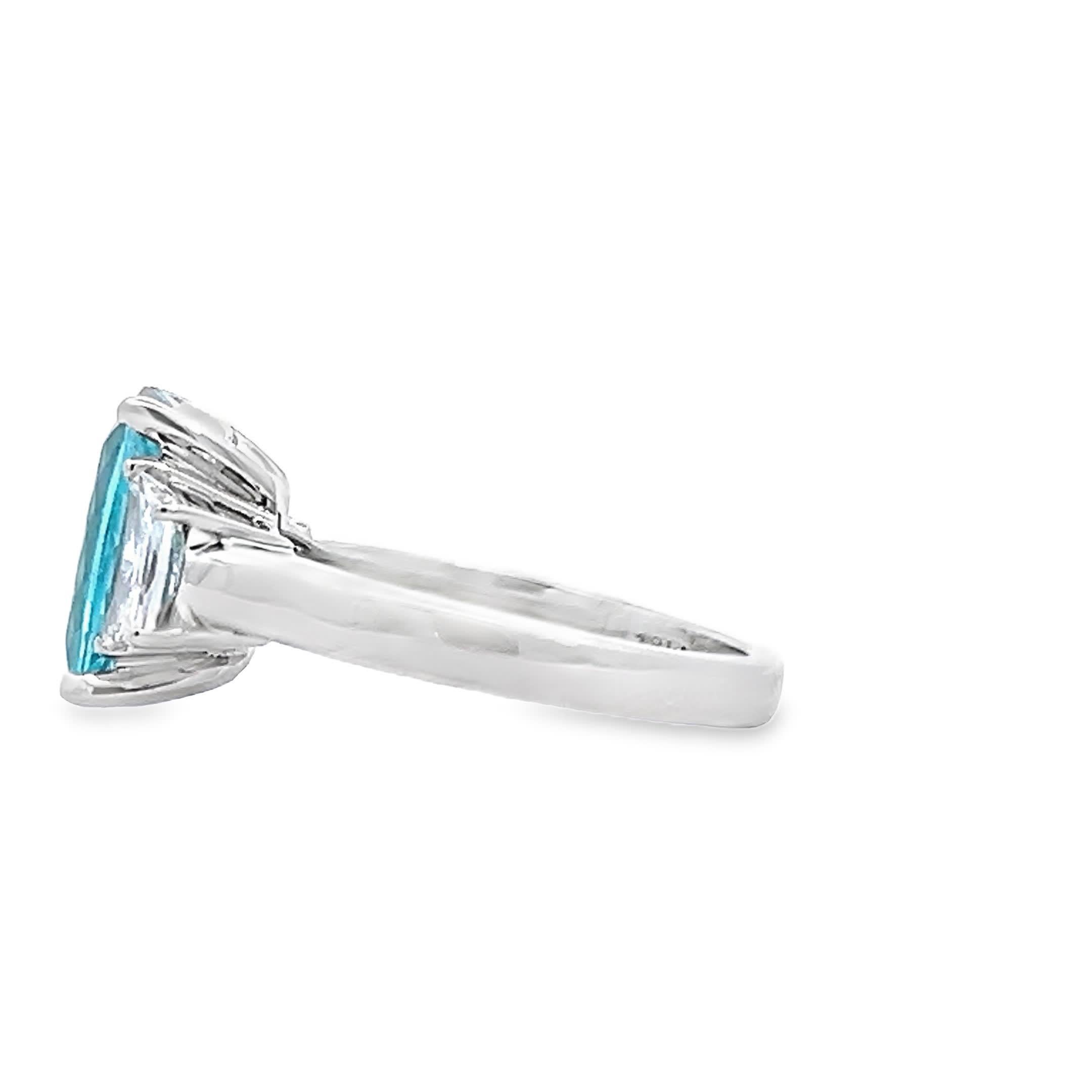 This exquisite ring features a vibrant turquoise gemstone, elegantly set between two sparkling diamonds. The unique color and brilliant cut make it a standout piece for any jewelry collection. Perfect for special occasions or as a statement