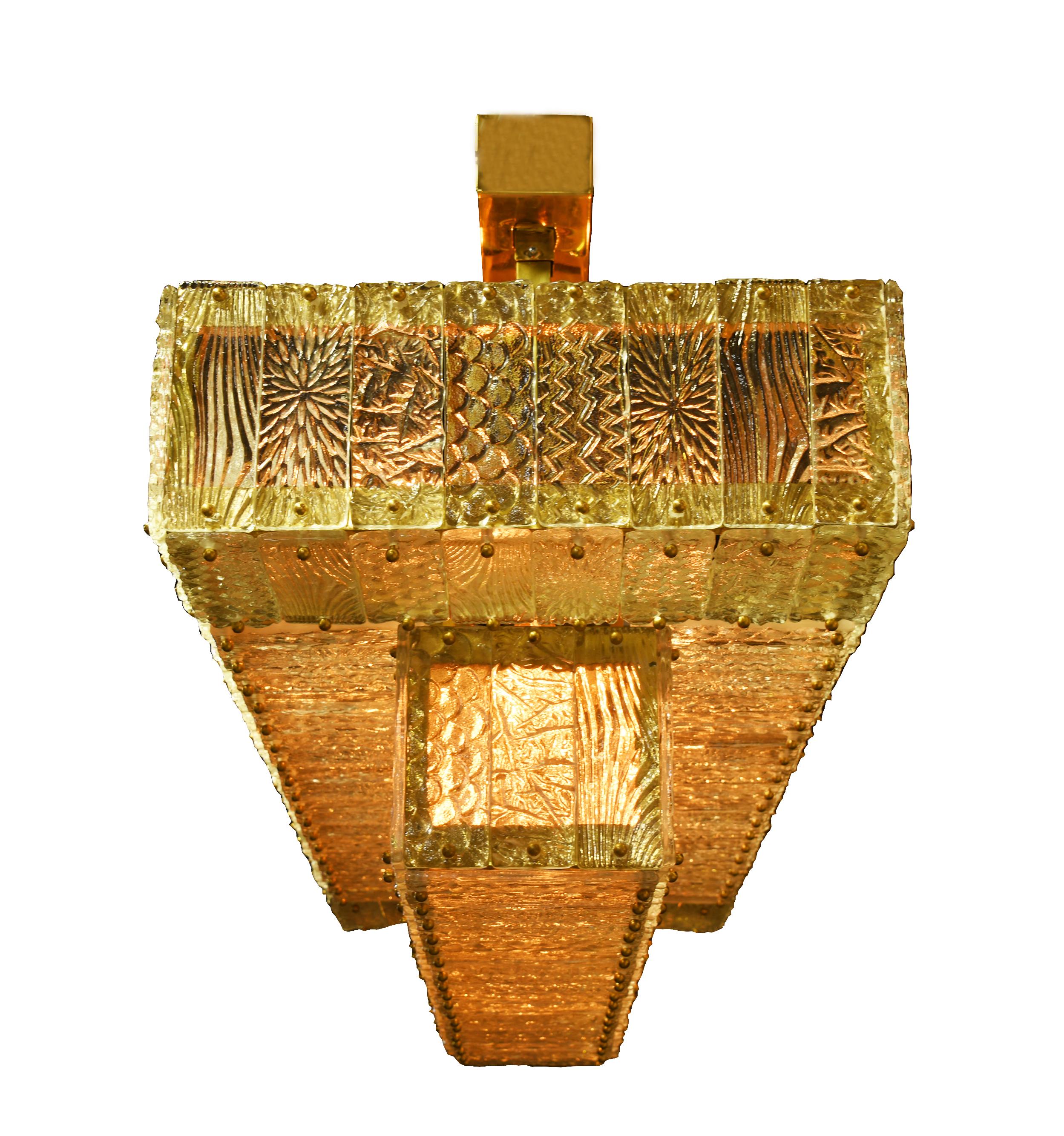A magnificent statement feature to suit a myriad of design styles from Art Deco – inspired to modern! Two tiers of hand cast champagne Murano glass flank a solid polished brass rectangular frame and canopy. 

Thomas Cooper Studio represents a