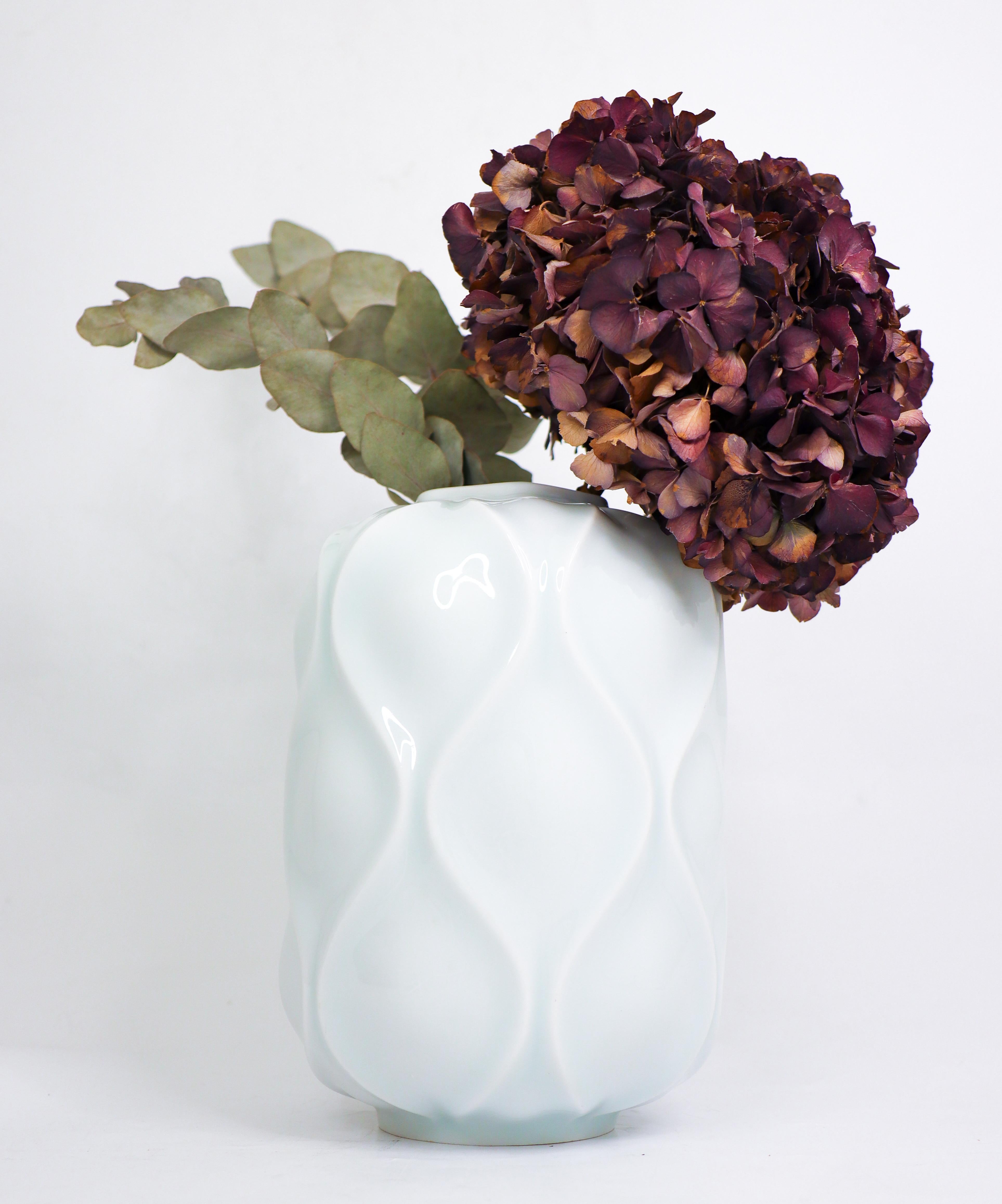 Un joli vase en porcelaine du rare modèle Bari conçu par Sven-Erik Skawonius dans les années 1950 à Upsala Ekeby Karlskrona. La couleur est blanche mais avec une touche de céladon et elle présente un magnifique motif en relief. Le vase est en