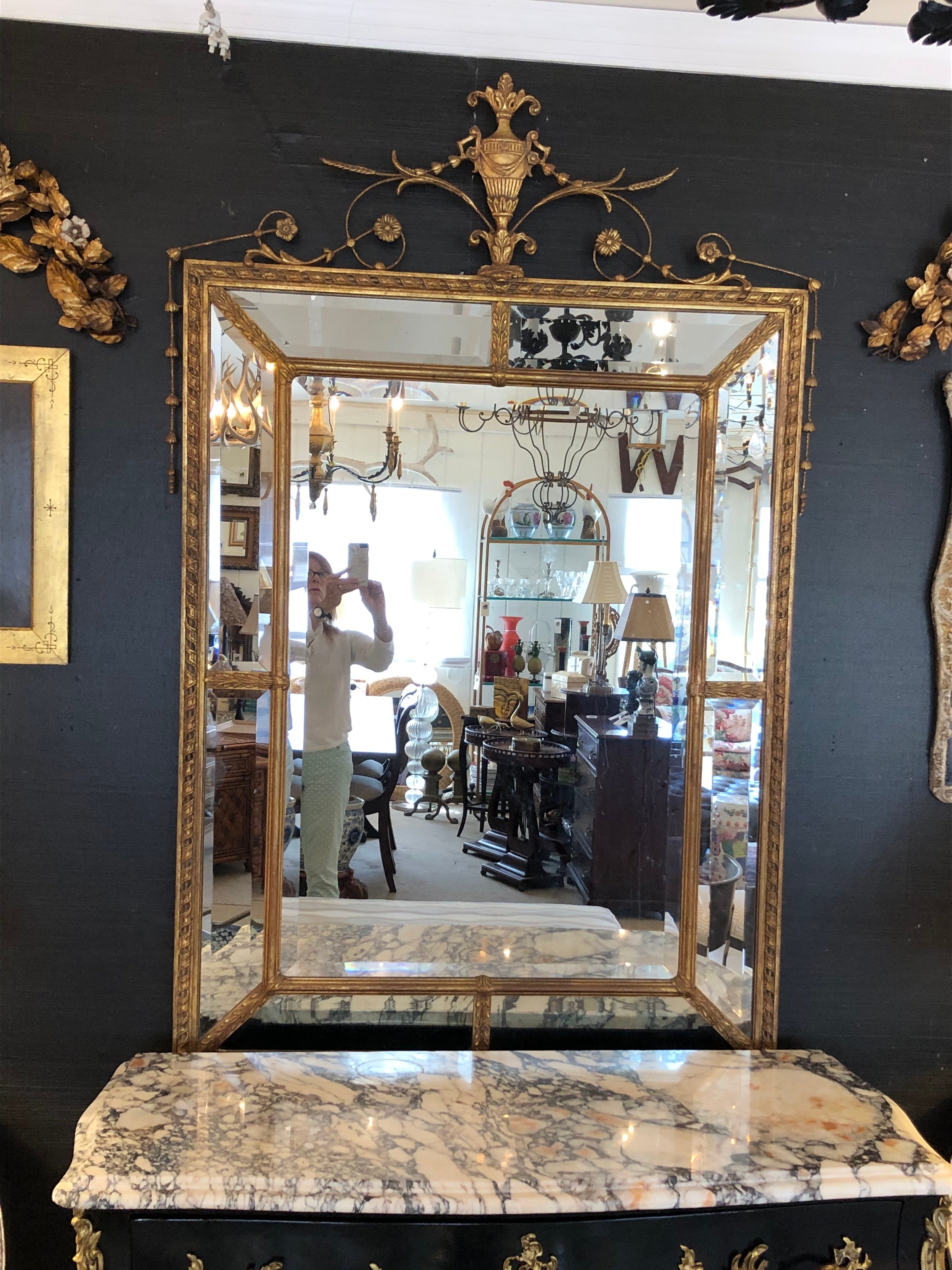 Sehr großer, eleganter Spiegel aus Goldholz mit mehreren abgeschrägten Spiegelflächen und einer geschnitzten Urne an der Spitze.  Innenspiegel 25,5 w  37 h



KamilleT




