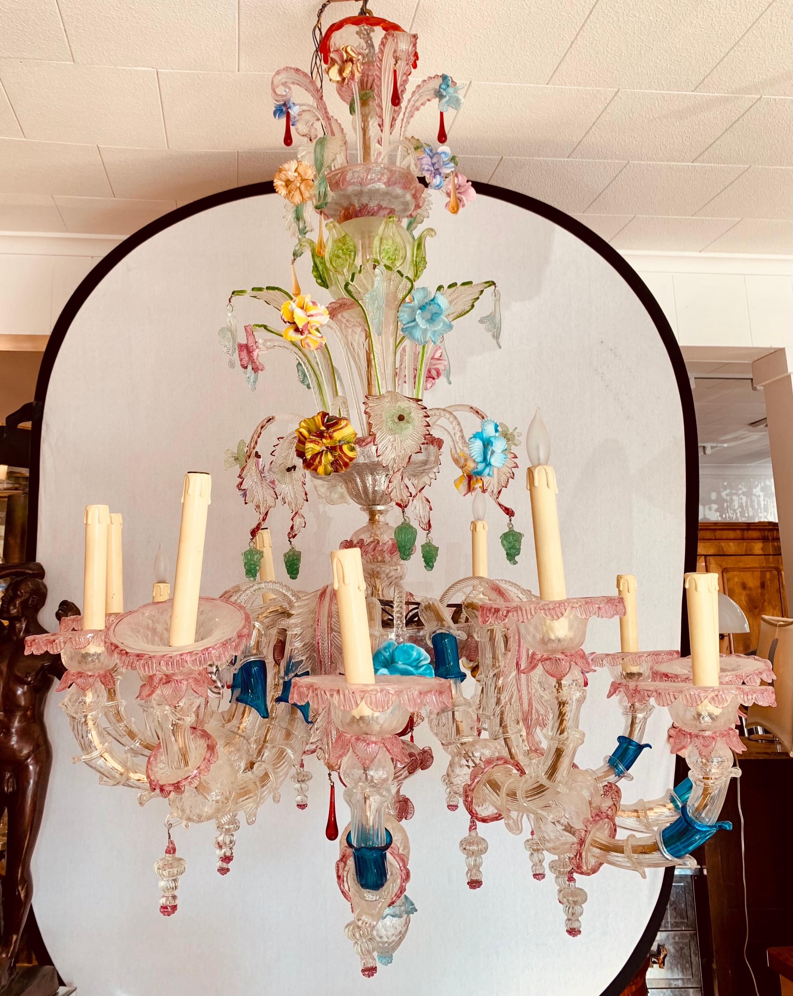 Extraordinary multi colored tiered Murano glass chandelier with twelve lights. Drop dead gorgeous lines and better color scheme.